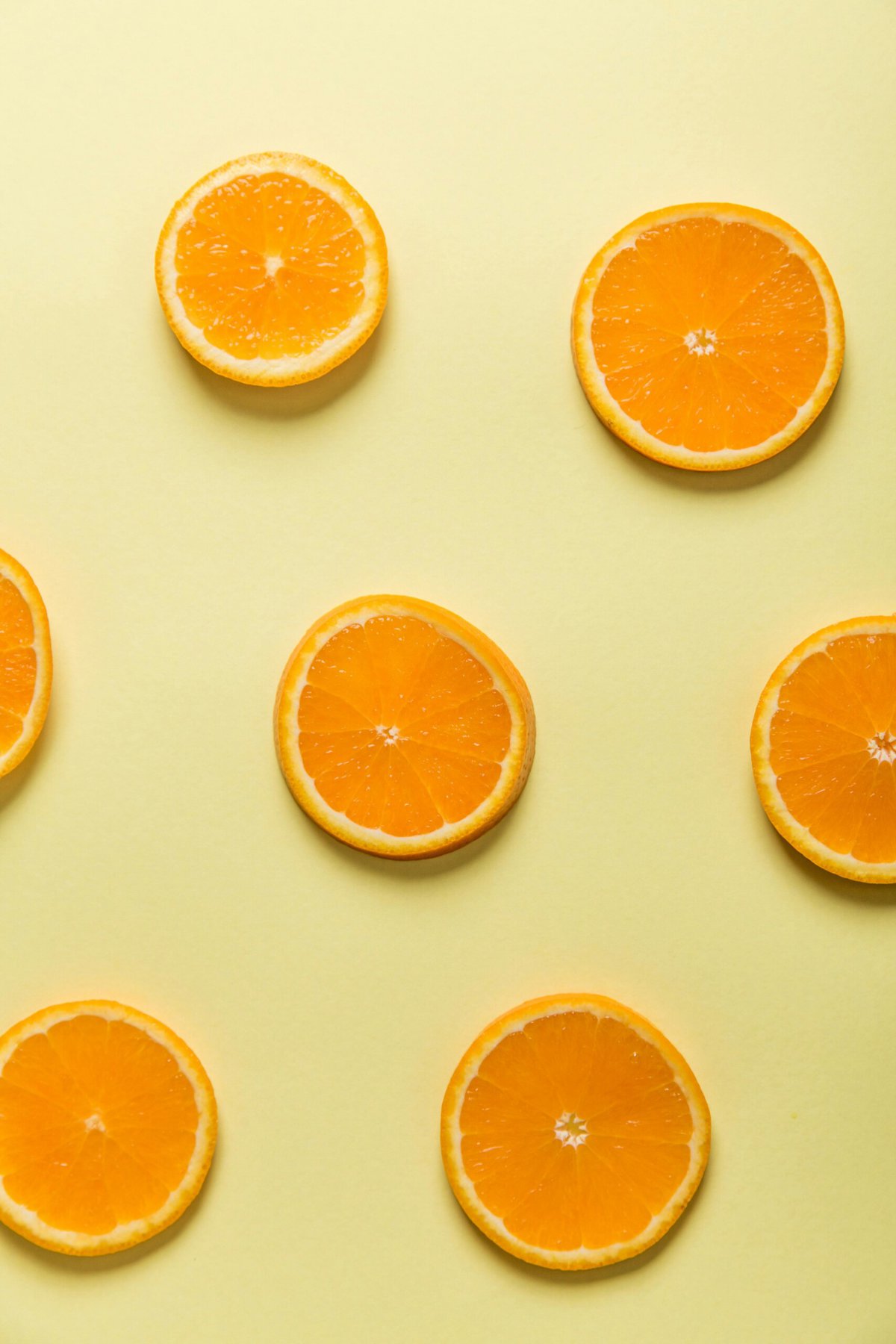 Orange slices on yellow background.