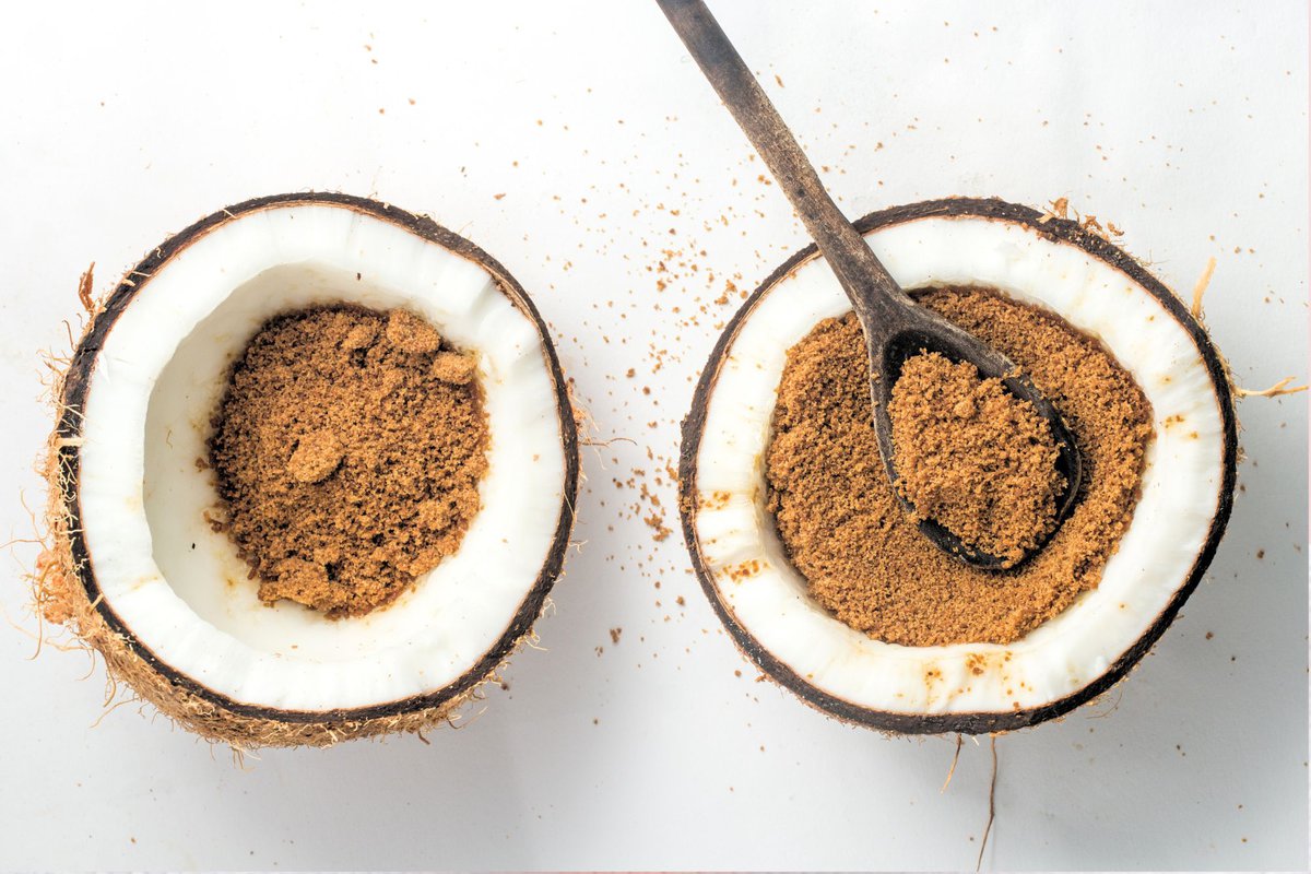 Coconut sugar inside 2 half opened coconuts.