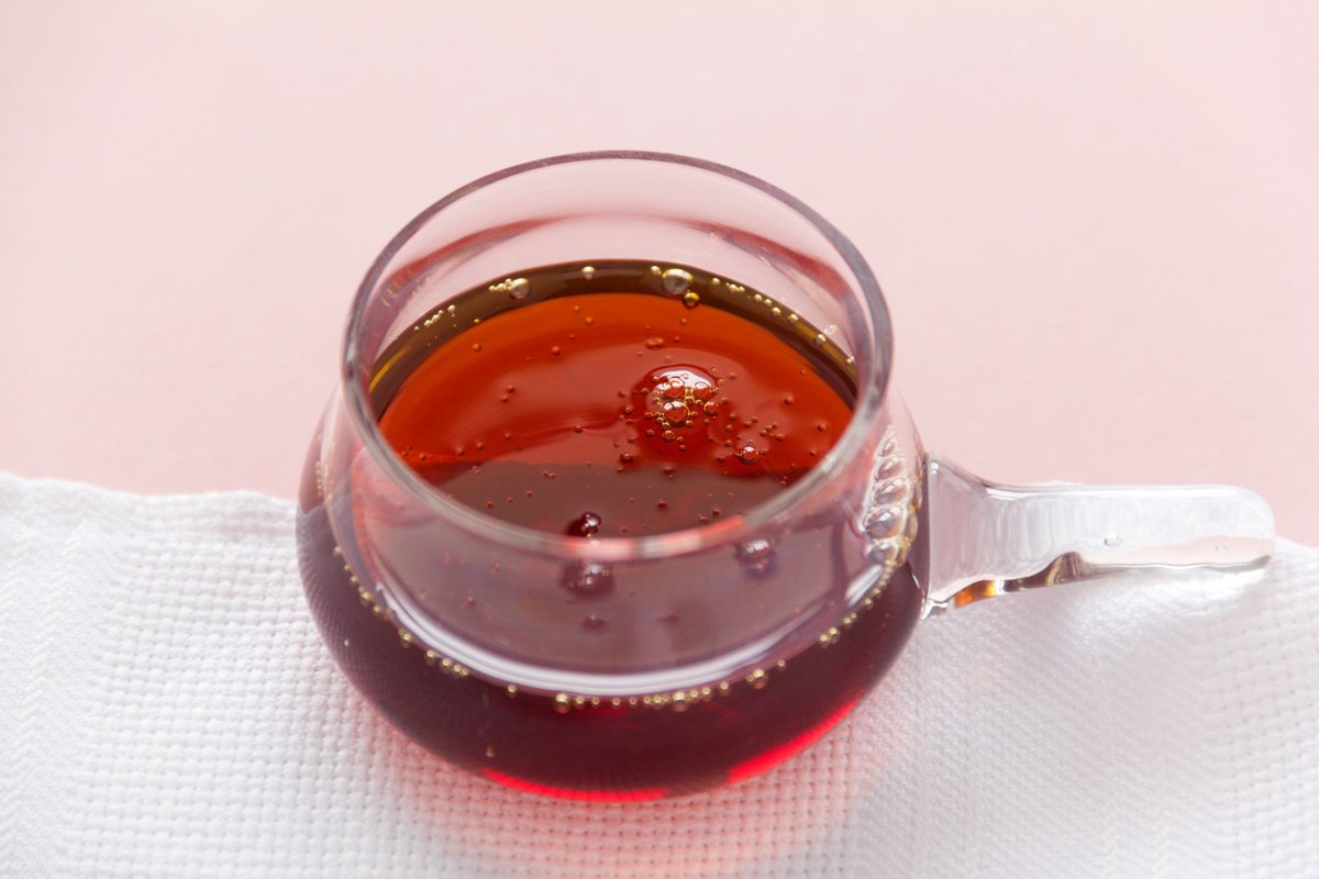 Maple syrup in a small glass.