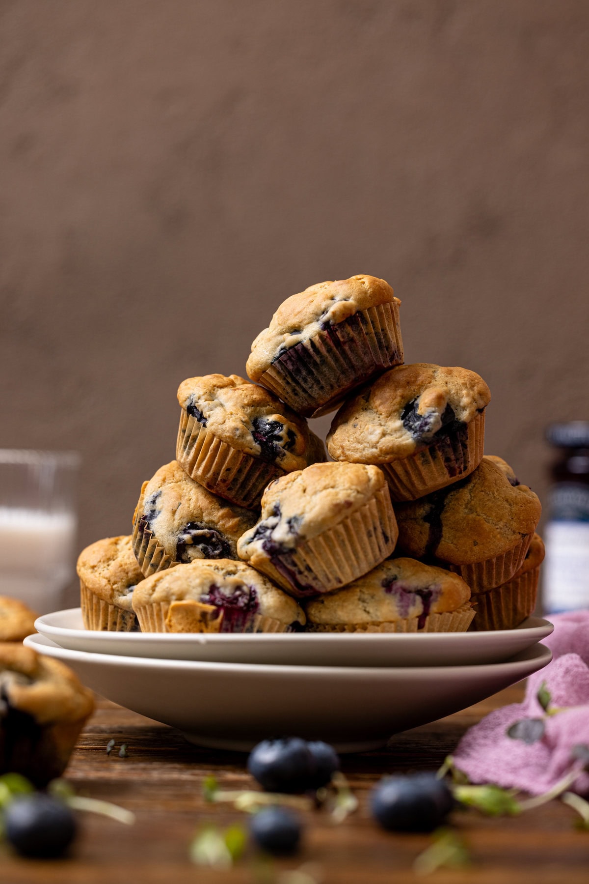 Stacked muffins on two plates.