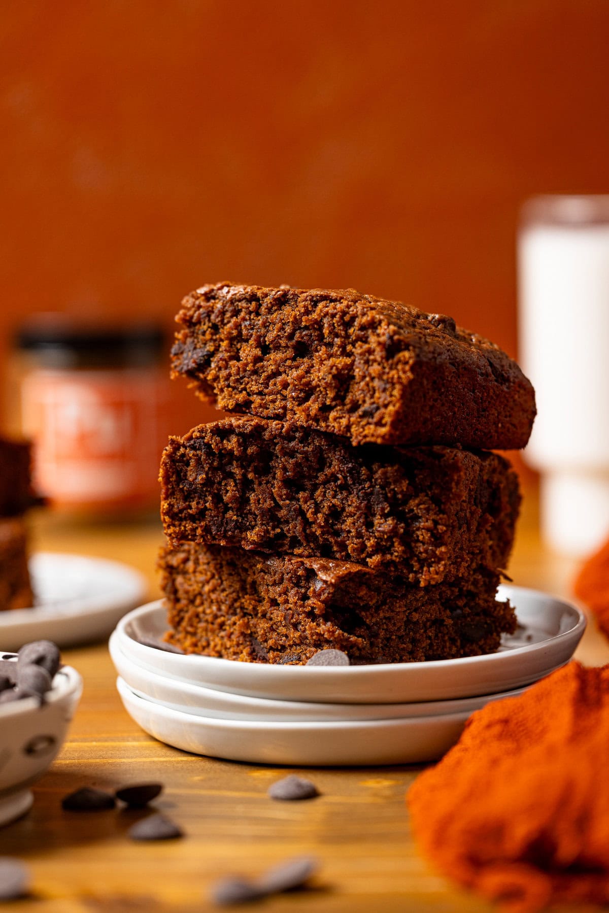 A stack of sweet potato brownies on white plates.