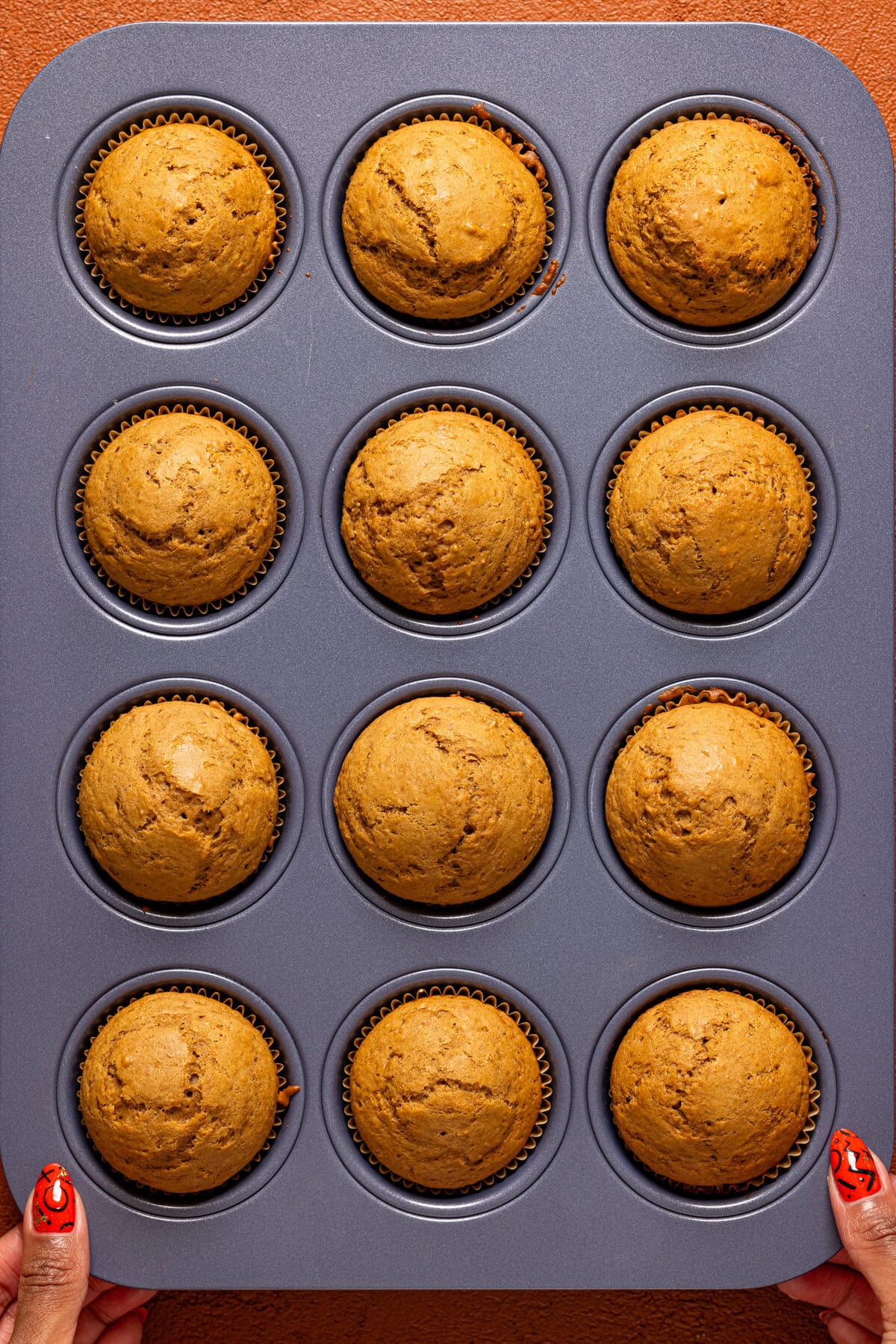 Muffins baked in lined muffin pan.