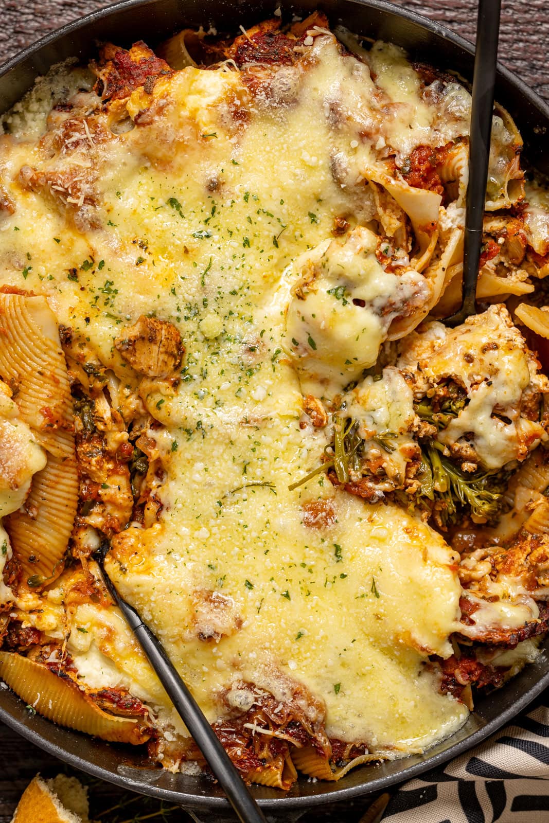 Up close shot of stuffed shells with two spoons.