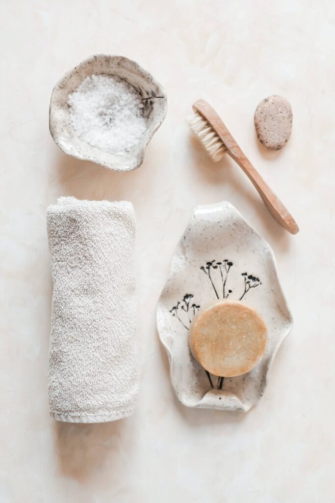 Table with a brush, towel, and other cleansing tools.