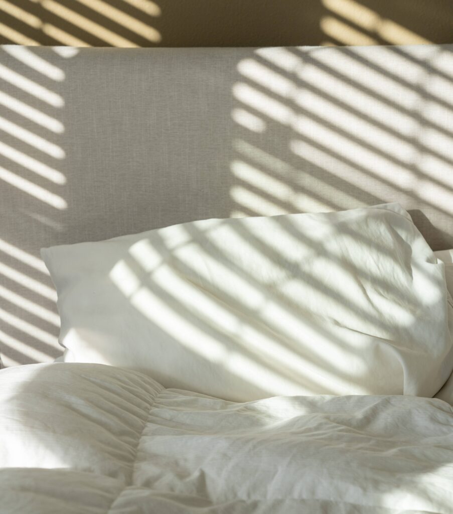 White pillow on a white bed
