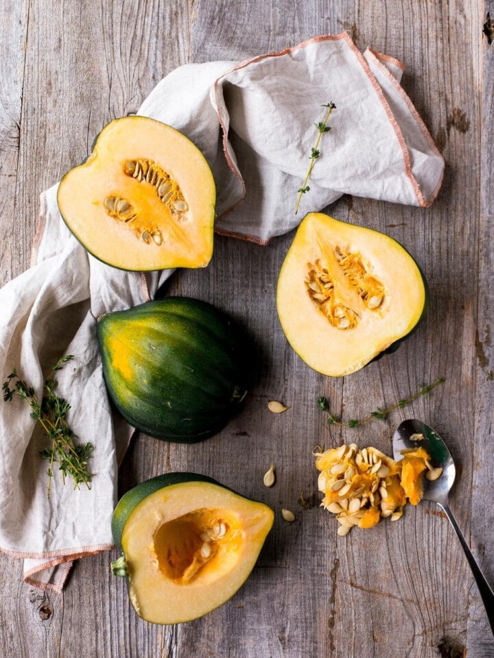 Acorn squash halves on a wooden table