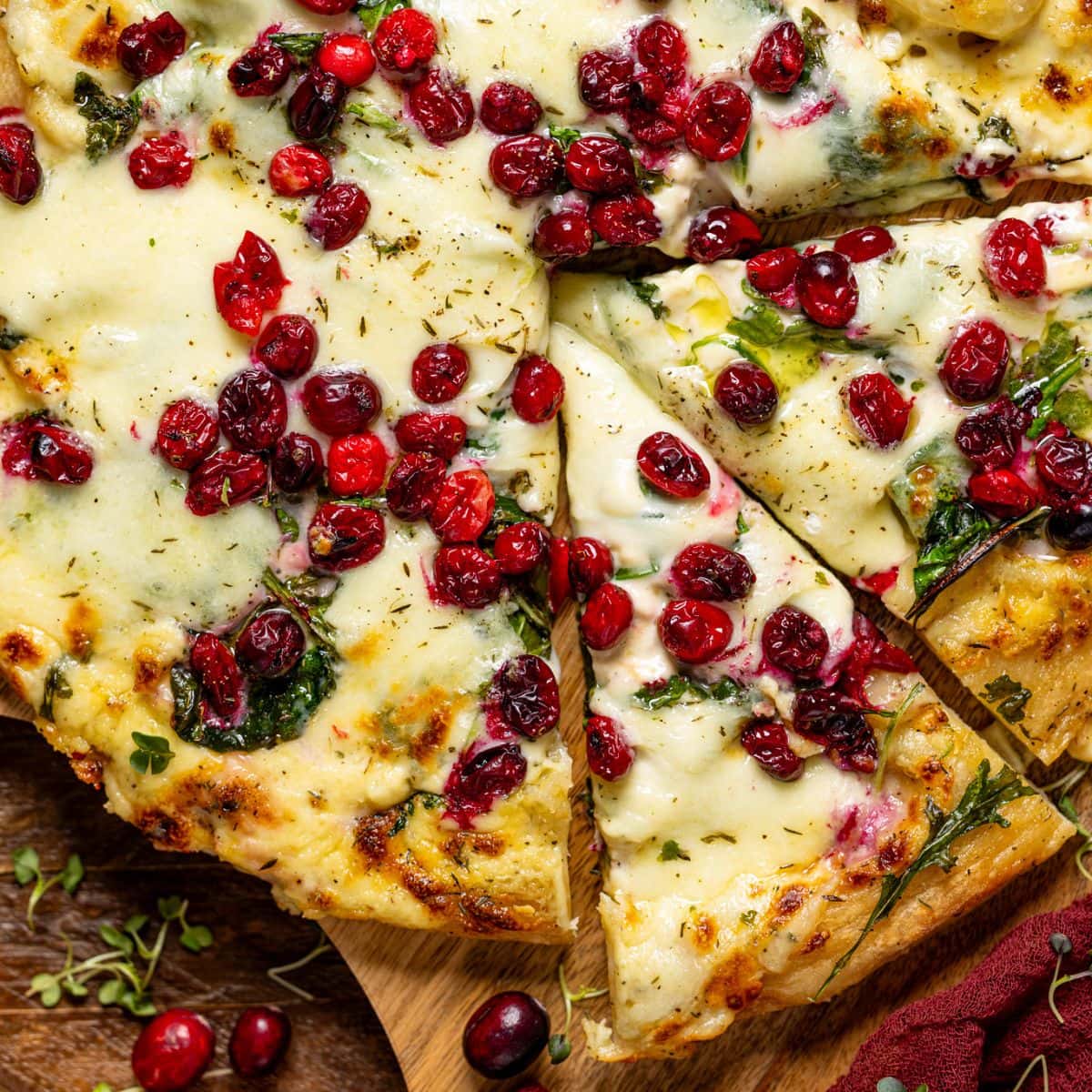 Pizza with two slices and cranberries.