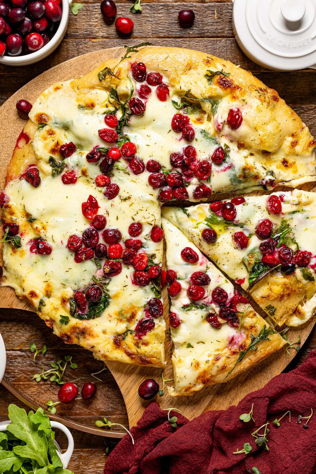 Baked Thanksgiving pizza pie with two slices.