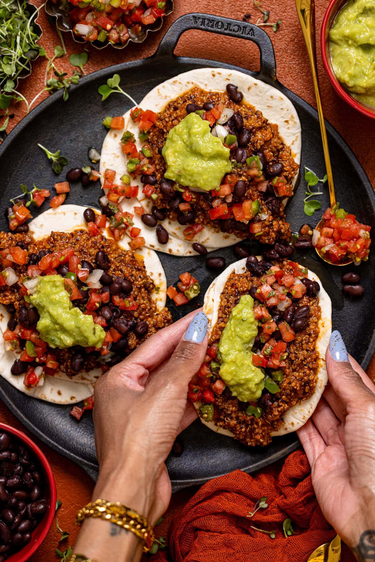 A Taco being held in a woman's hand and folded.