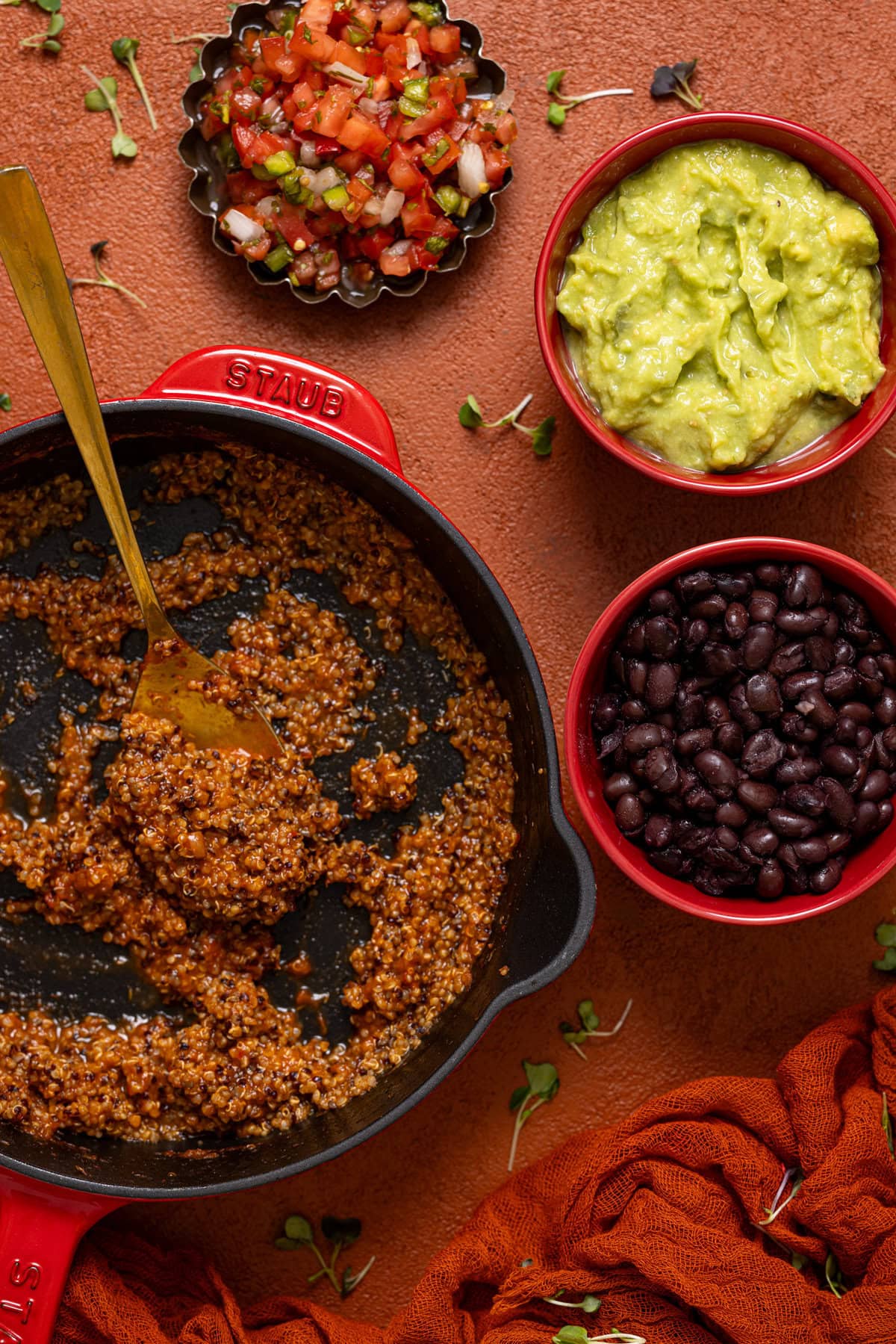 All taco ingredients on a burnt orange table.