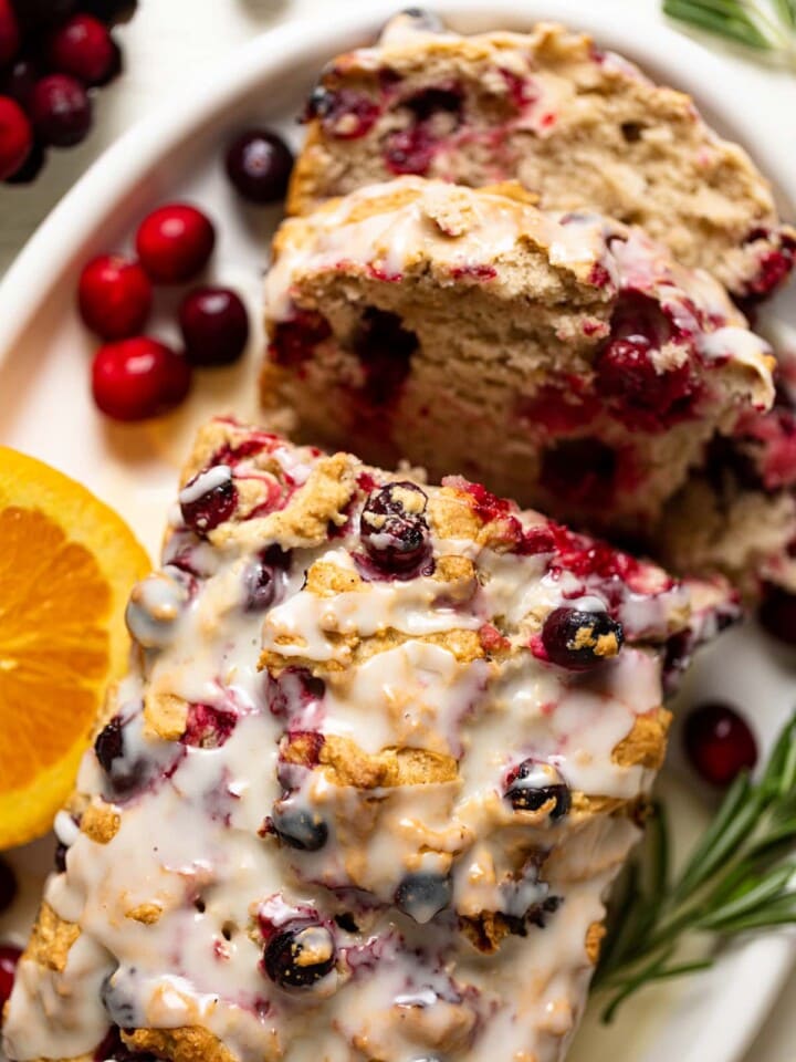 Overhead shot of a half-sliced loaf of Vegan Orange Cranberry Bread