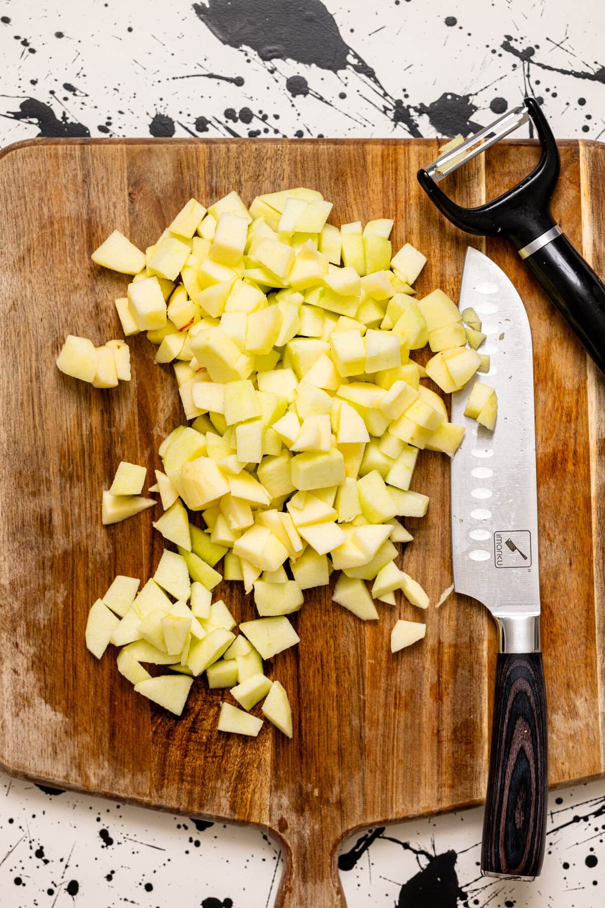 Chopped apples on a cutting board with a knife.