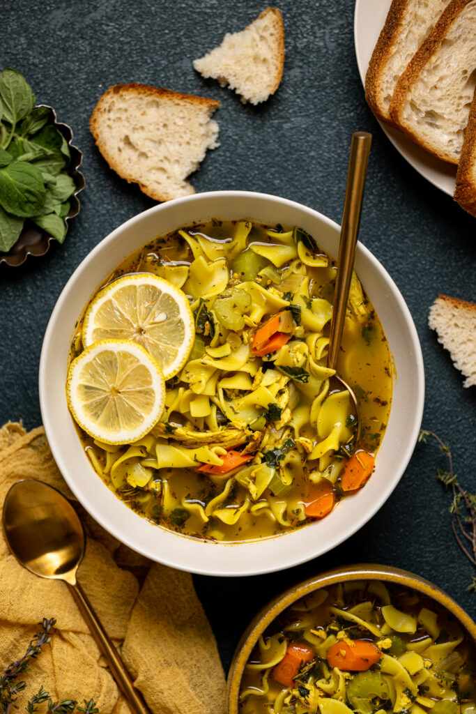 Bowl of Nourishing Chicken Noodle Soup with lemon slices