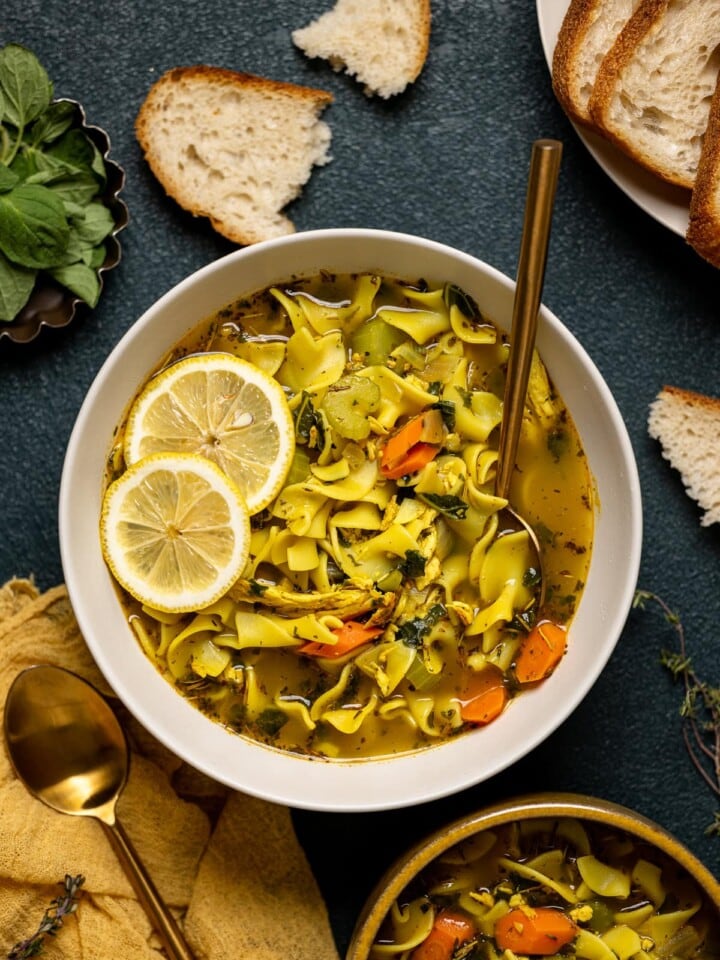 Bowl of Nourishing Chicken Noodle Soup with lemon slices