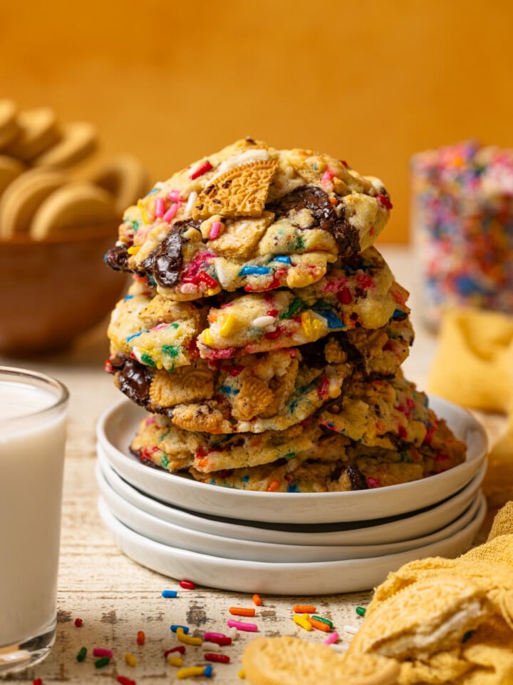 Up close shot of stacked cookies on a white plates.