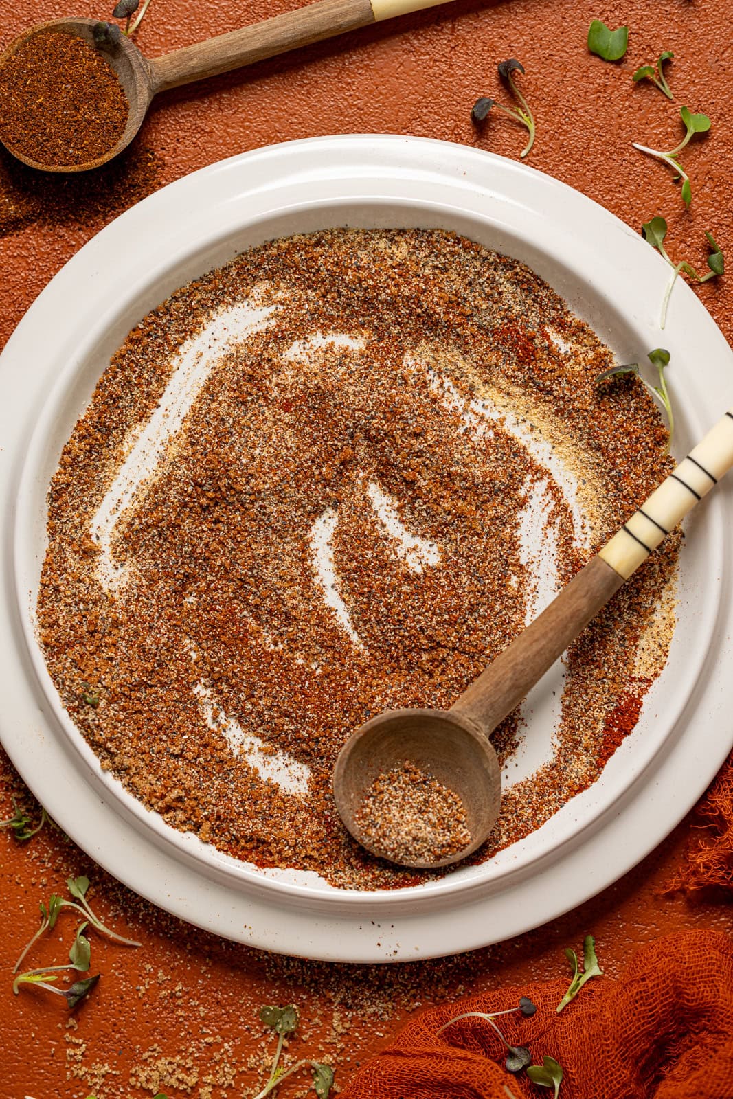 Seasoning on a white plate with two spoons. 