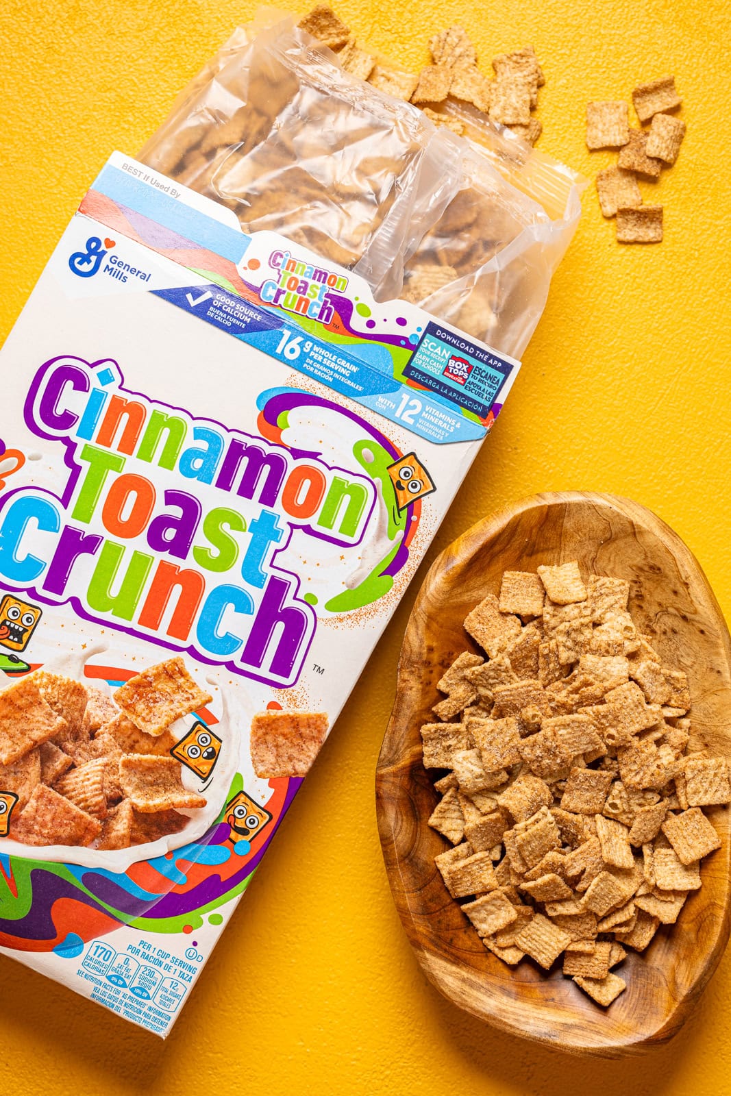 Bow of cinnamon crunch cereal on a yellow table.