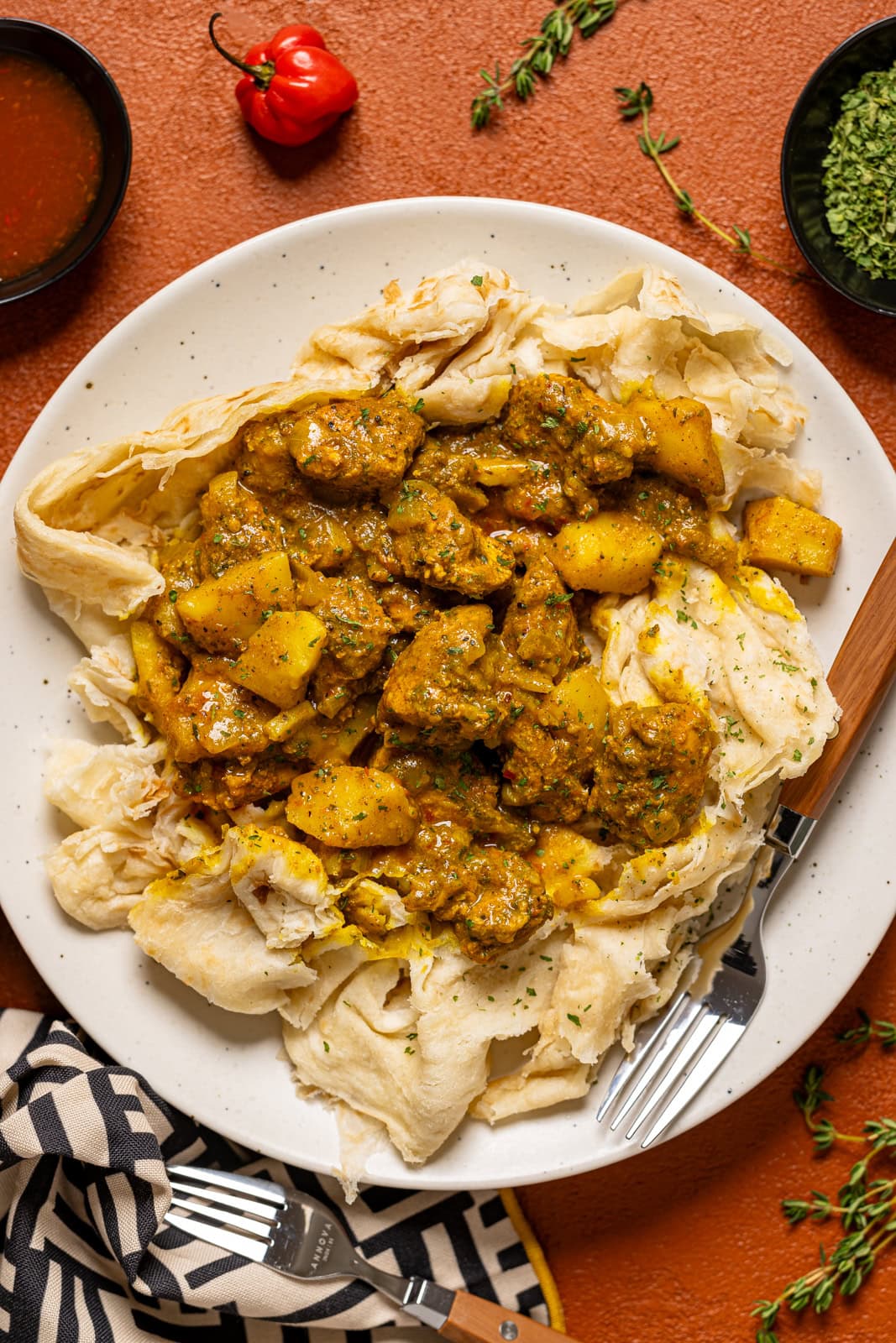 Curry chicken roti on a plate with a fork.