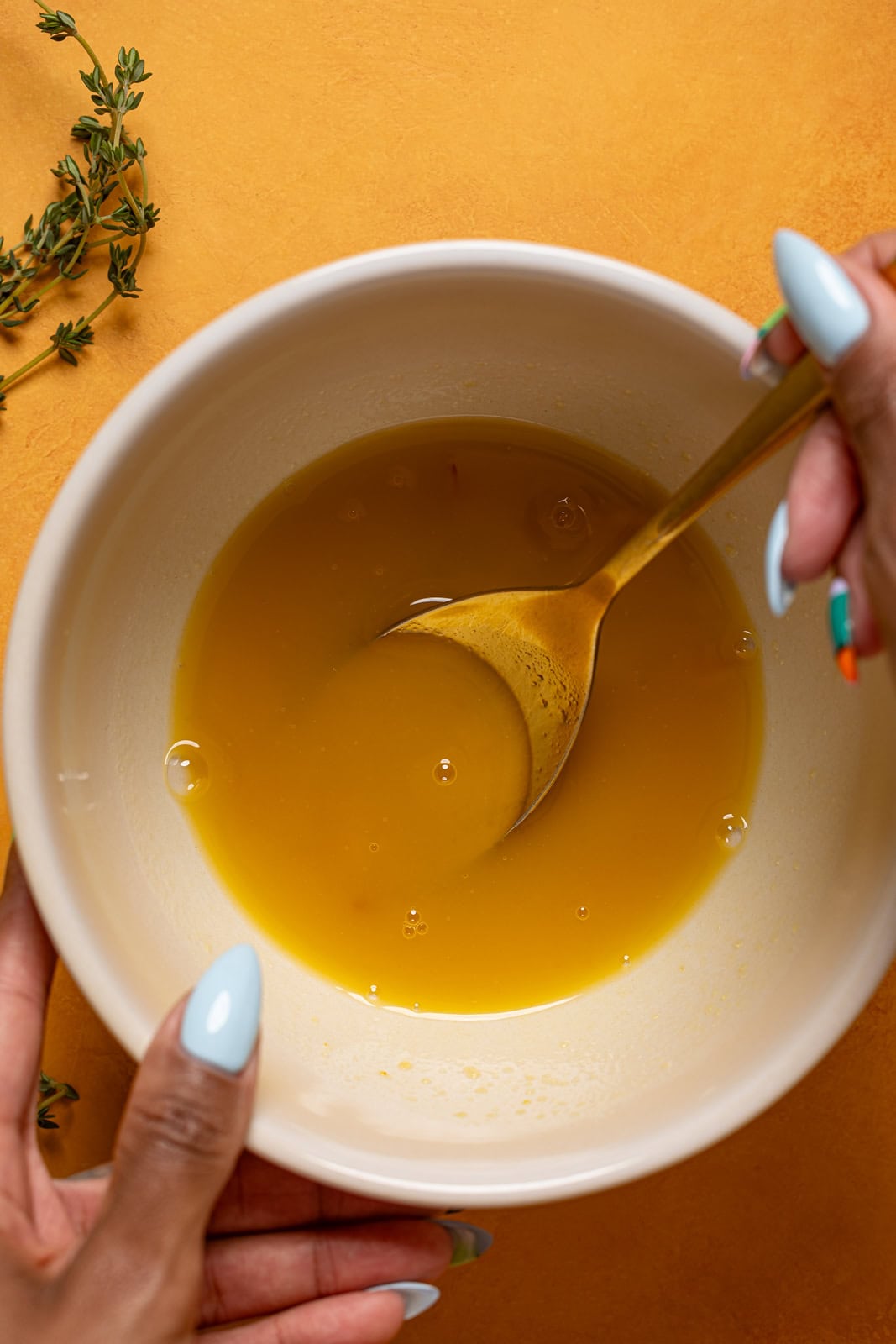 Mocktail mixture being stirred in a bowl.