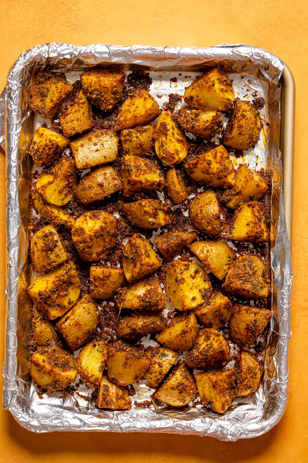Roasted potatoes on a baking sheet lined with foil.