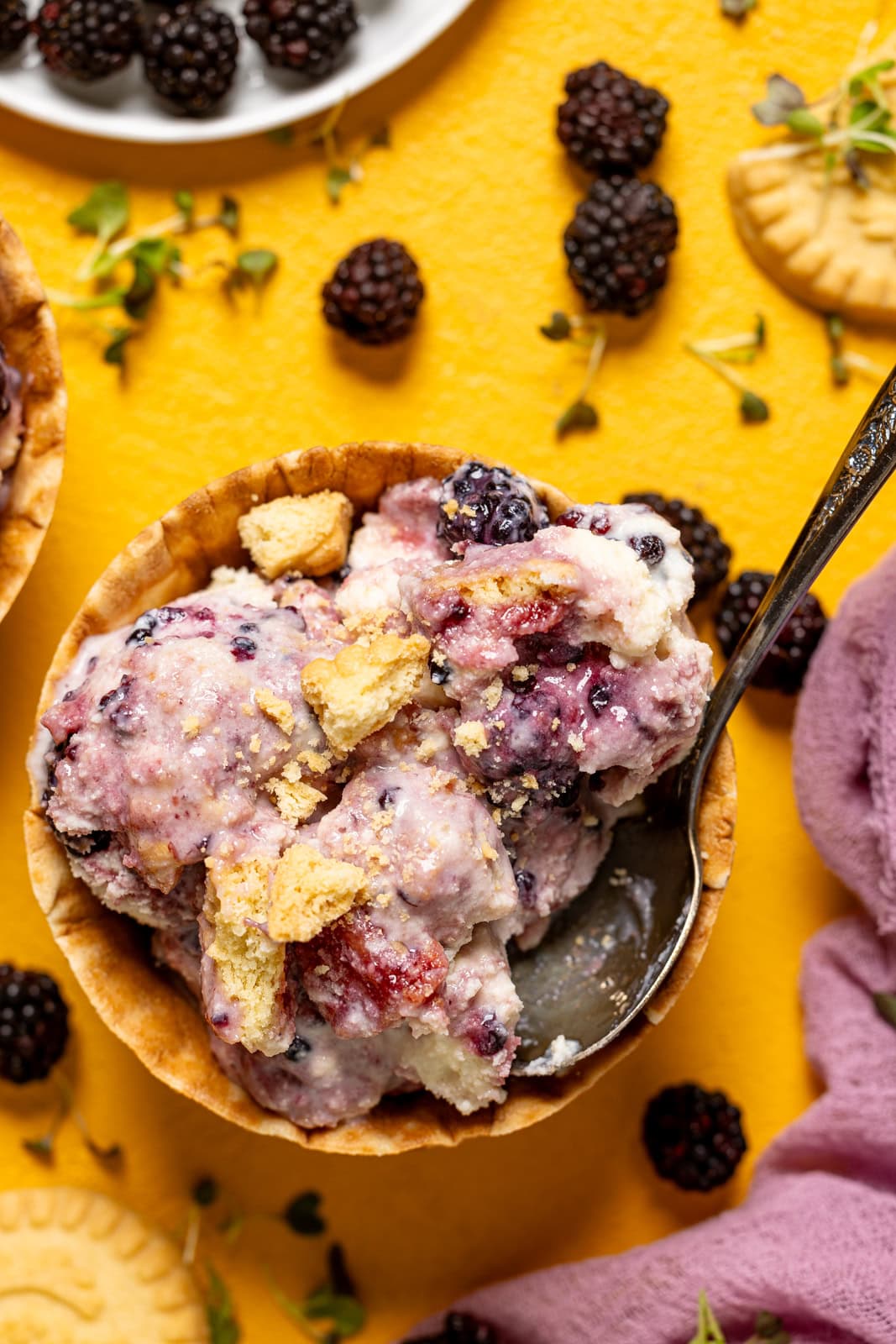 Up close shot of blackberry ice cream with a spoon.
