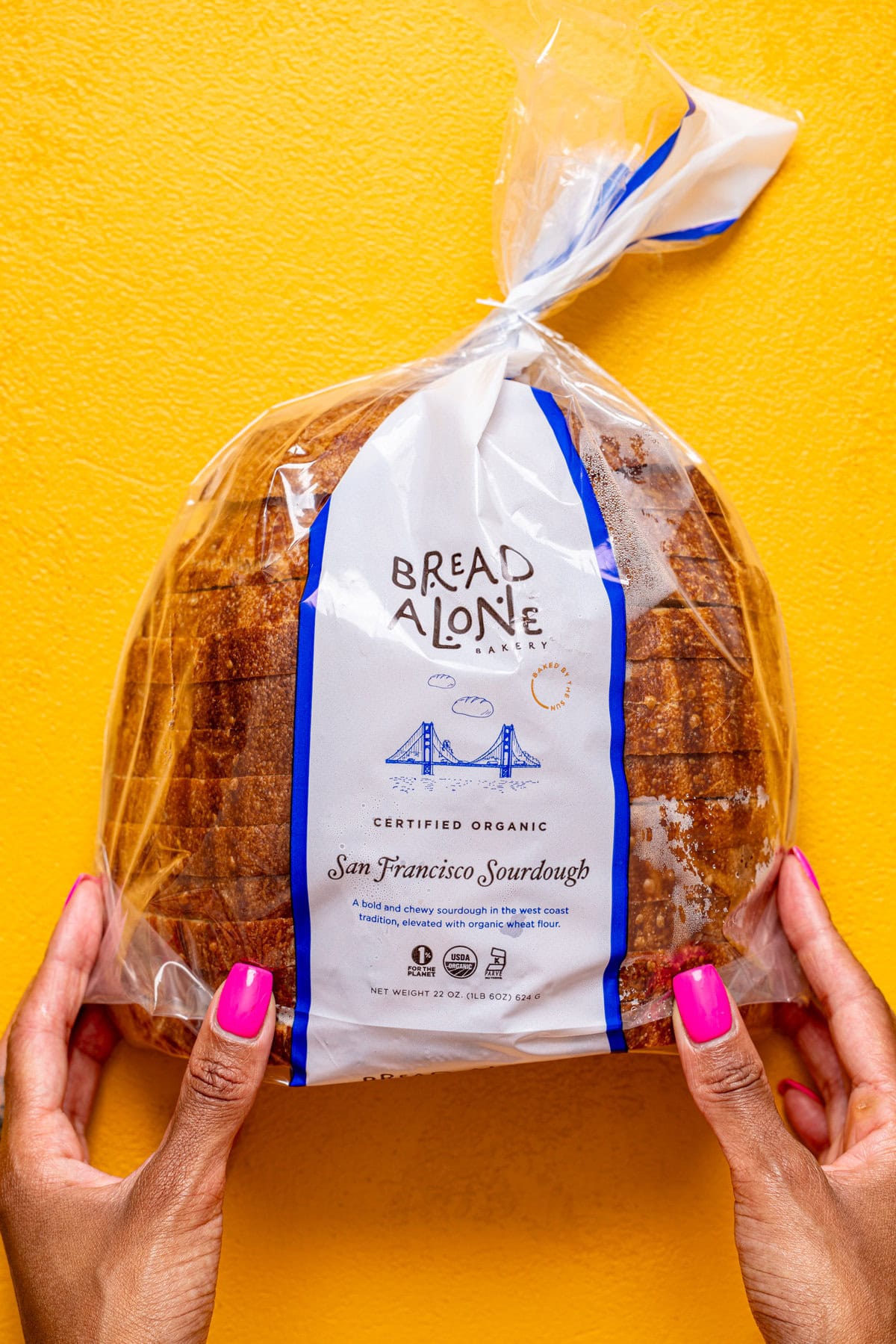 Pack of sourdough bread being held with hands.