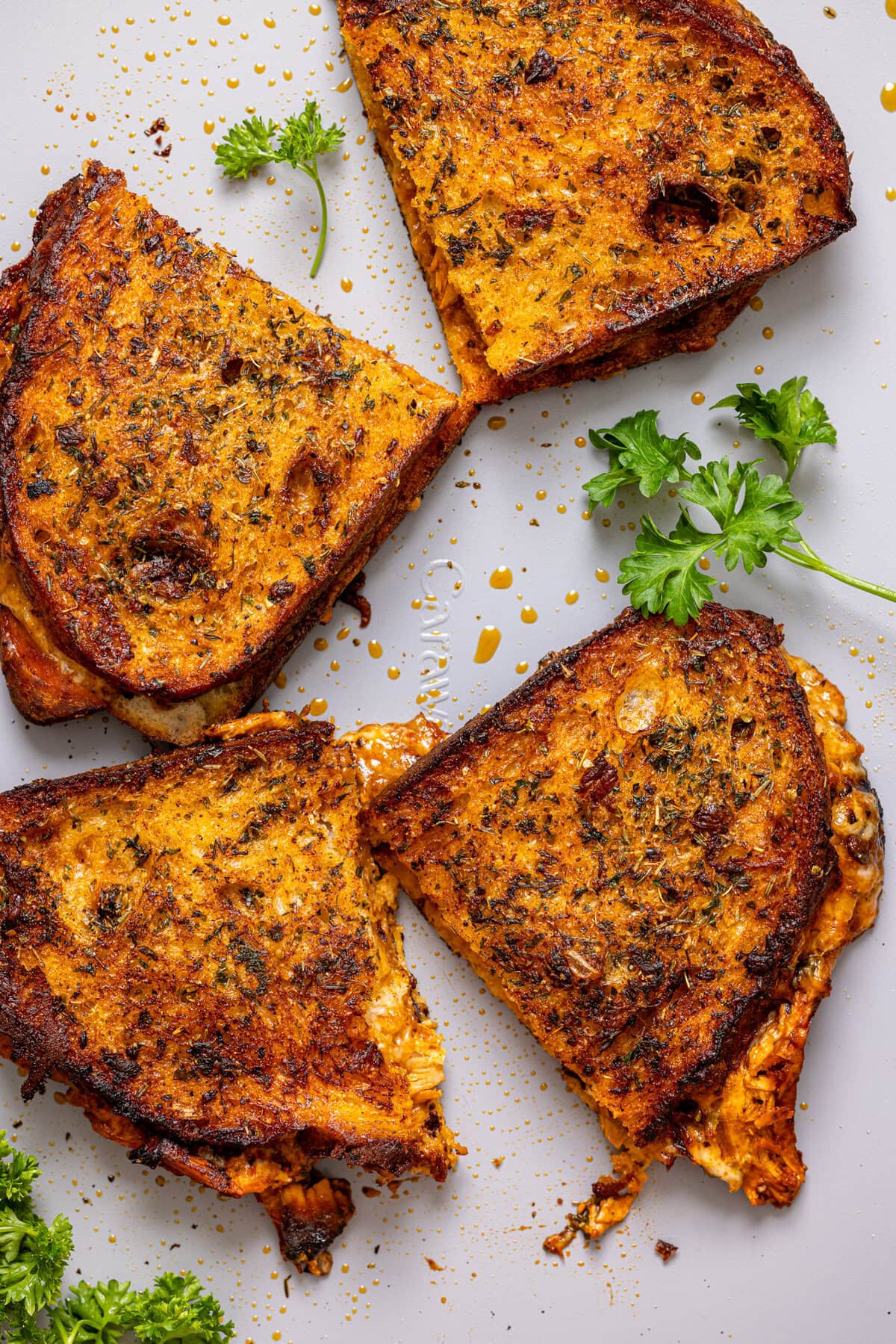 Sliced grilled cheese on a baking sheet.