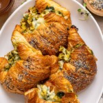 Breakfast croissants on a white serving platter.