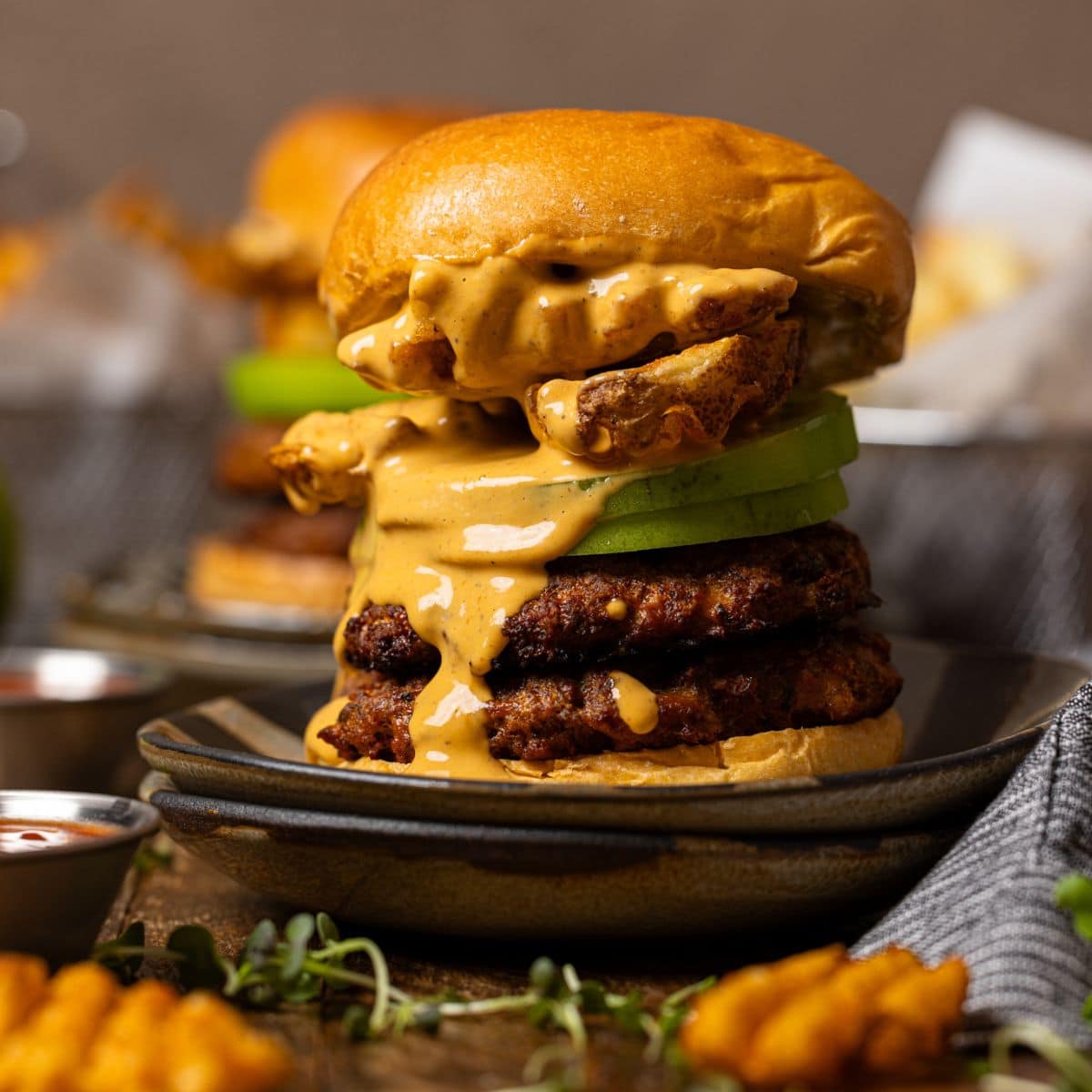 Smash burger with sauce and fries.