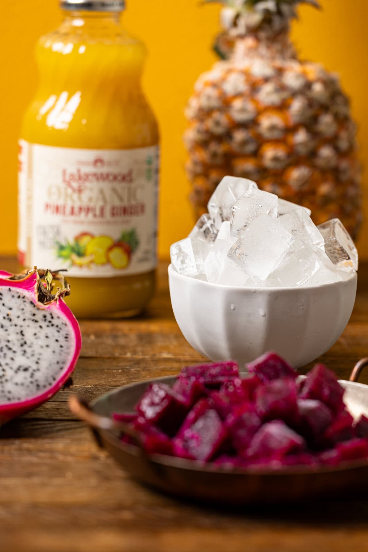 Ingredients on a brown wood table with a yellow background. 