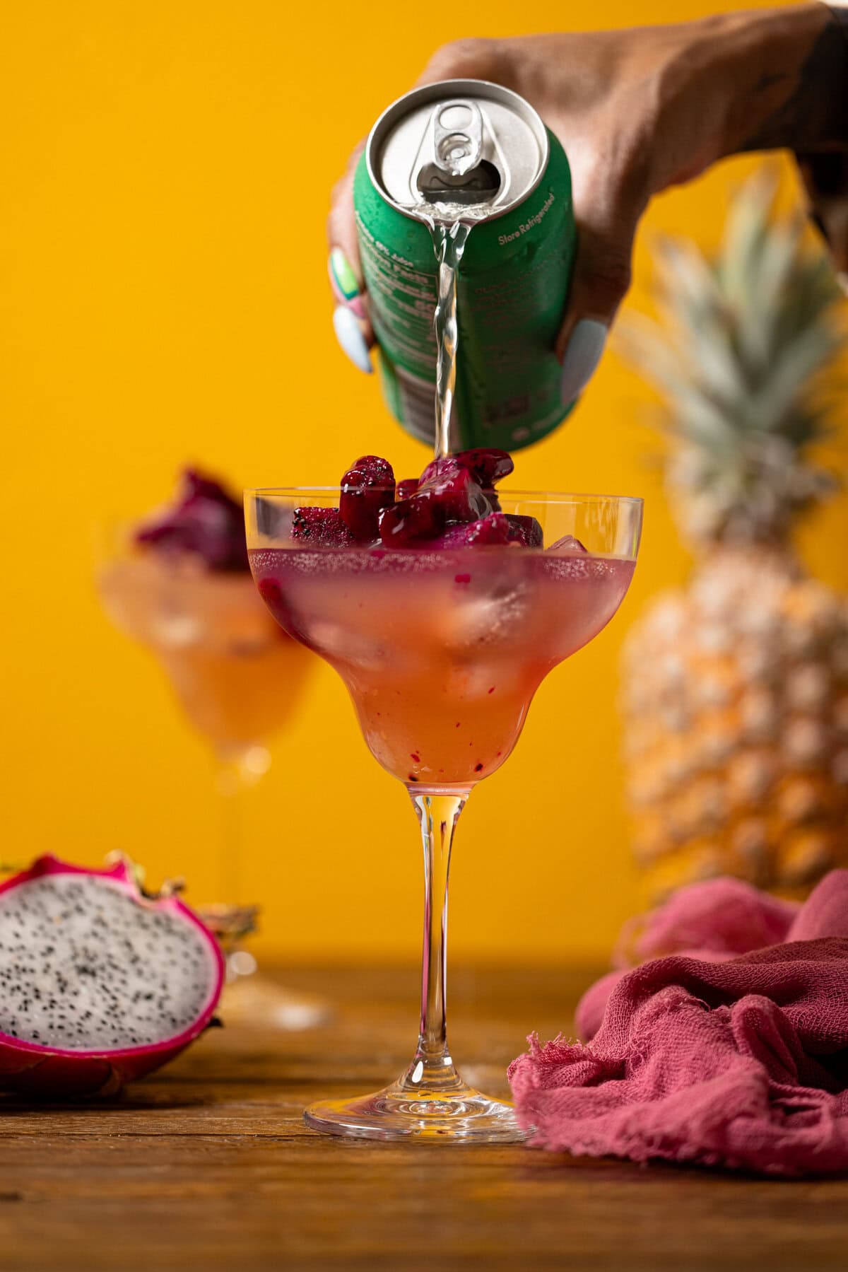 Can of soda being poured into mocktail glasses as topping.