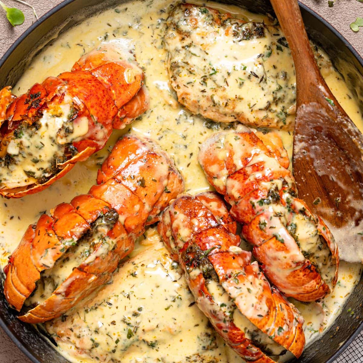 Lobster and salmon in creamy sauce in a skillet.