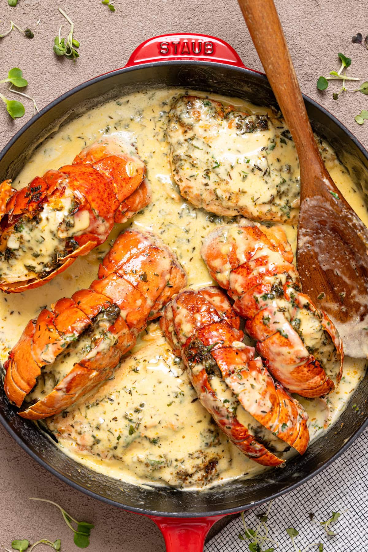 Lobster and salmon in creamy sauce in a skillet.