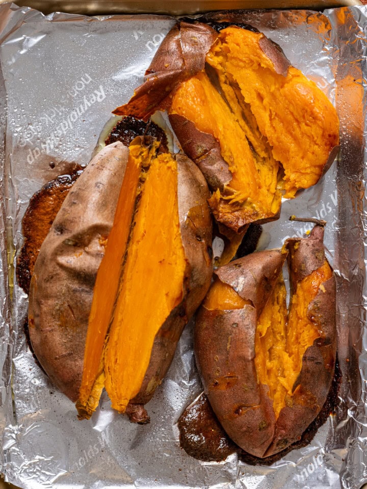 Cut baked sweet potatoes on a baking sheet with foil paper.
