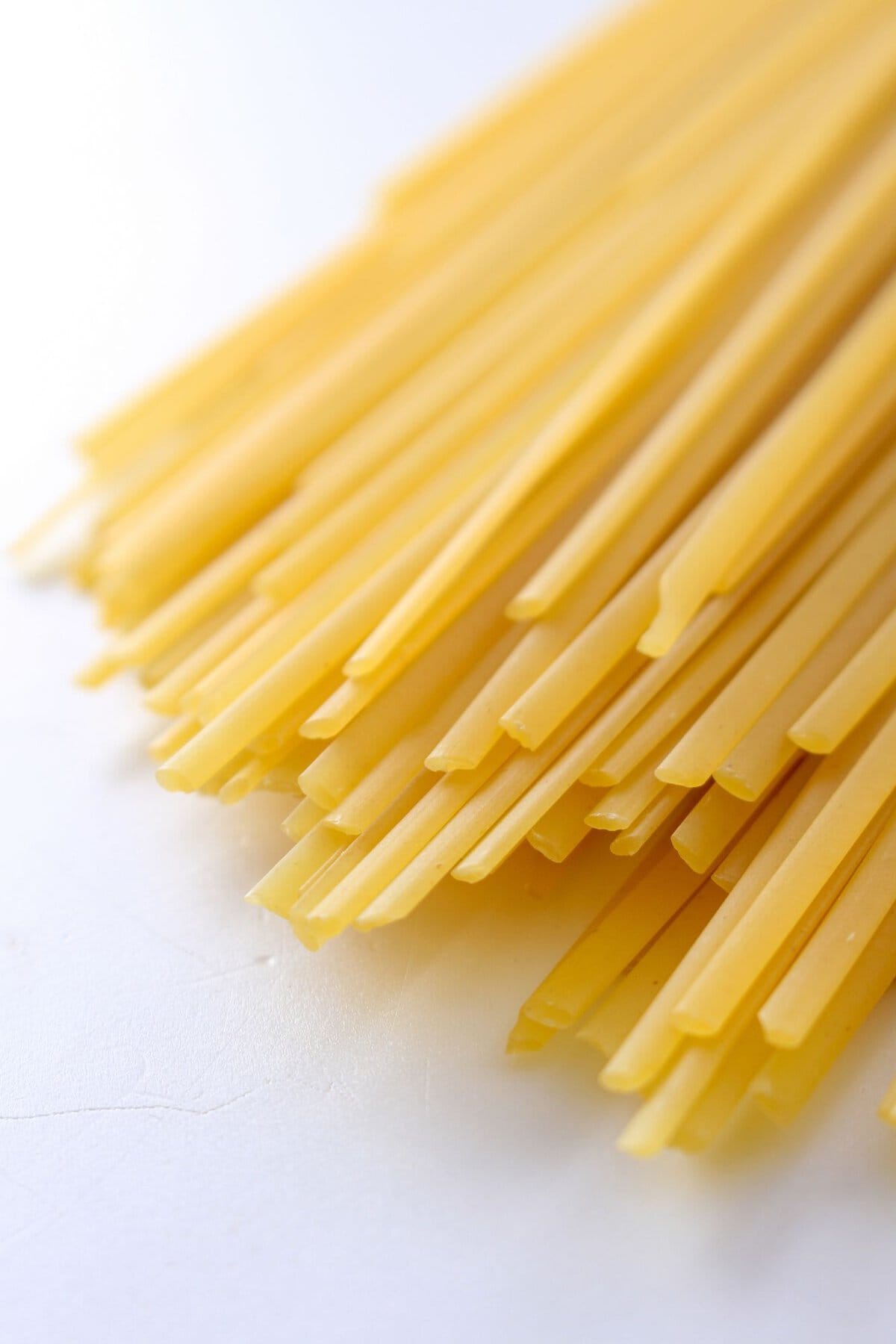 Linguine pasta on a white table.