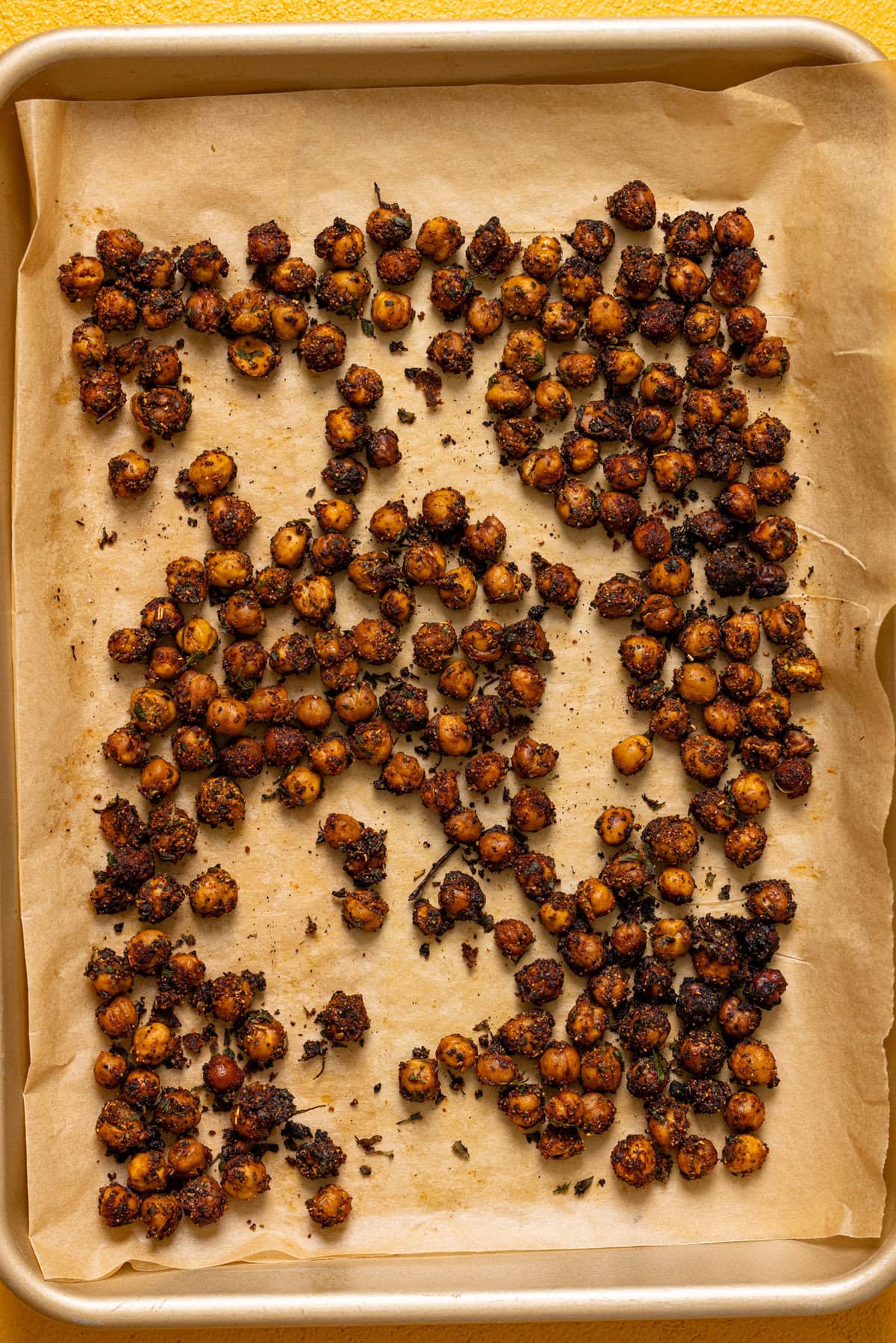 Roasted chickpeas on a baking sheet with parchment paper. 