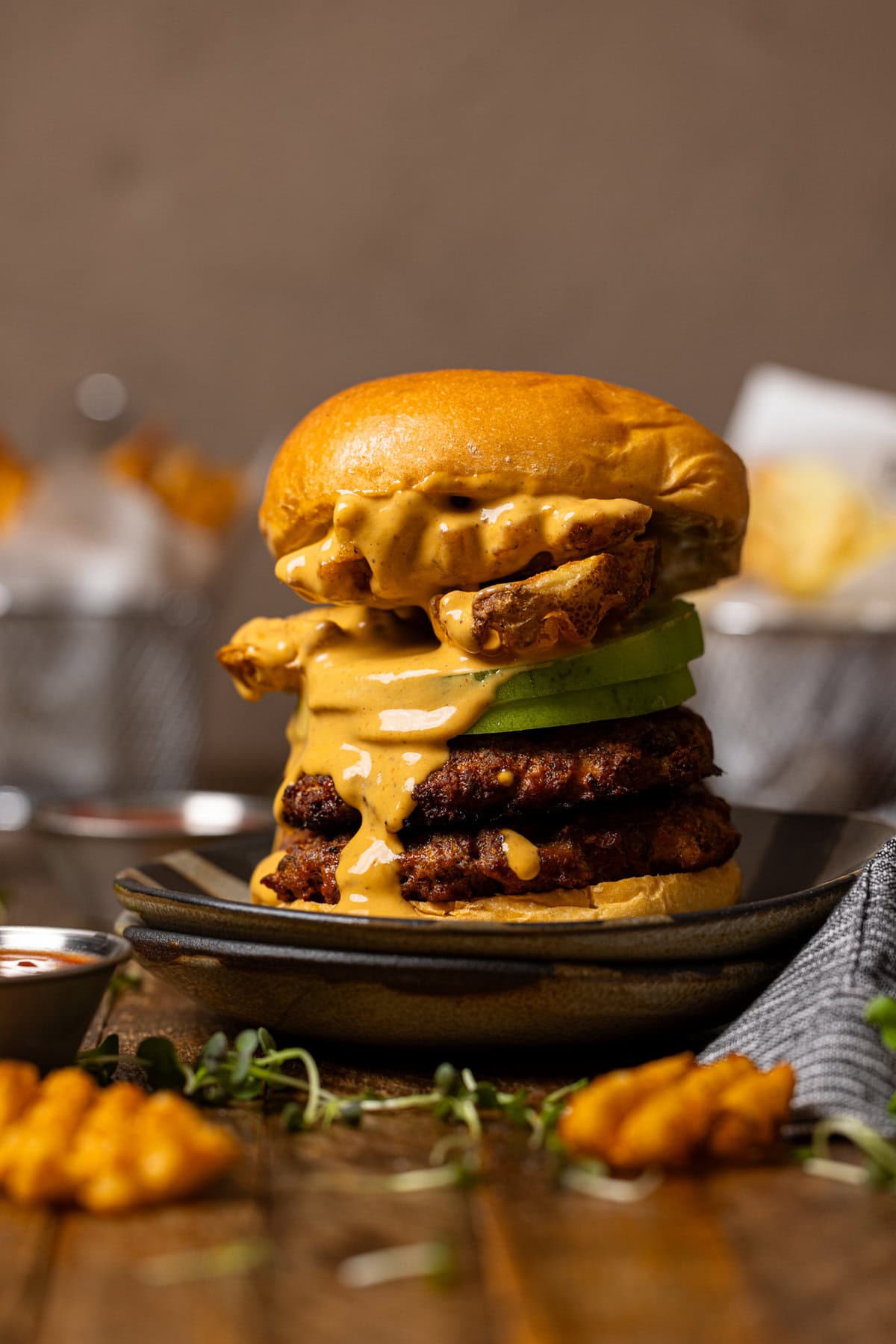 Smash burger with sauce and fries.