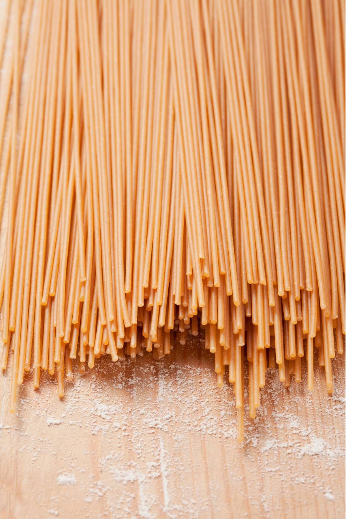 Spaghettin pasta on a beige table.