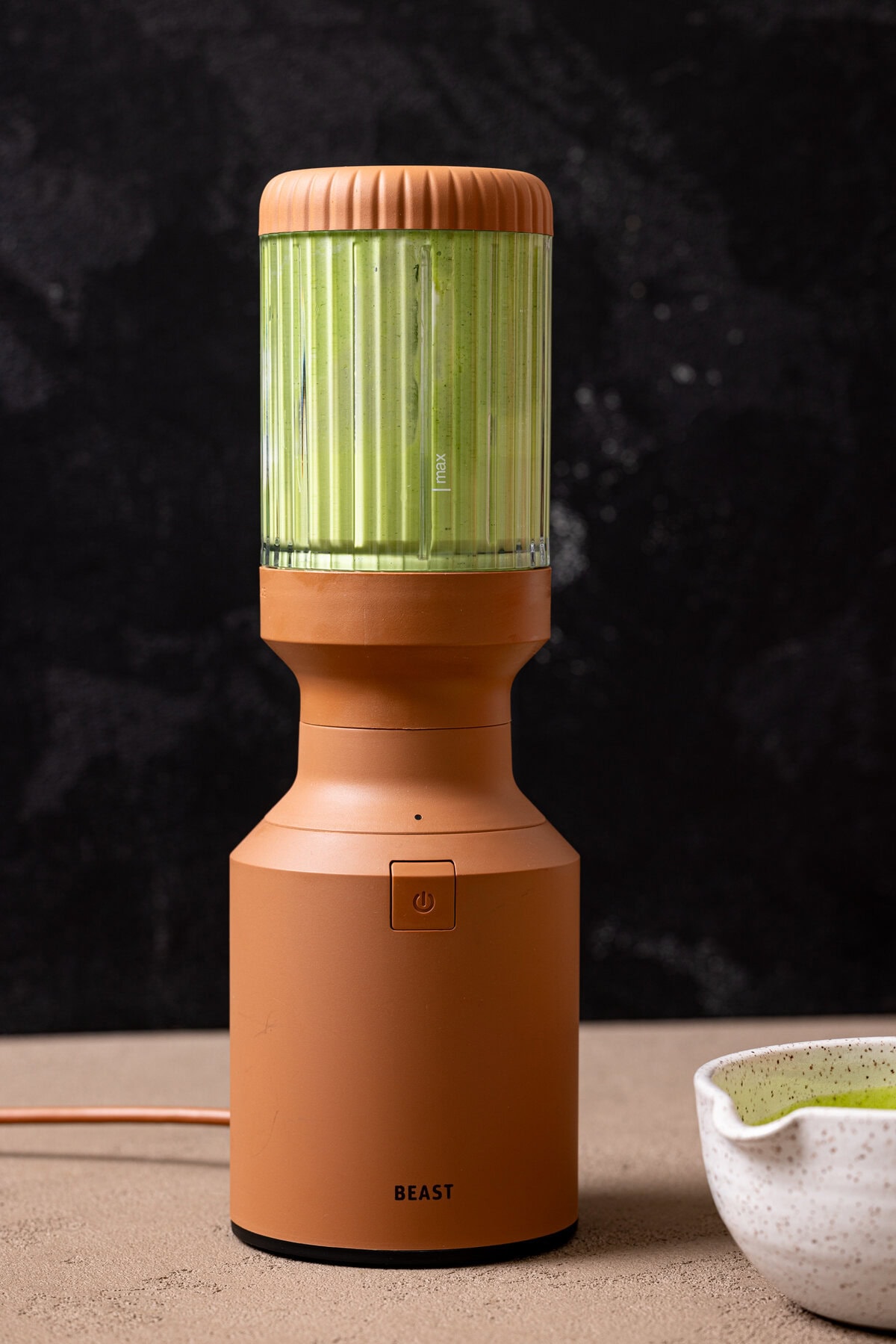 Green sauce in a brown blender. 