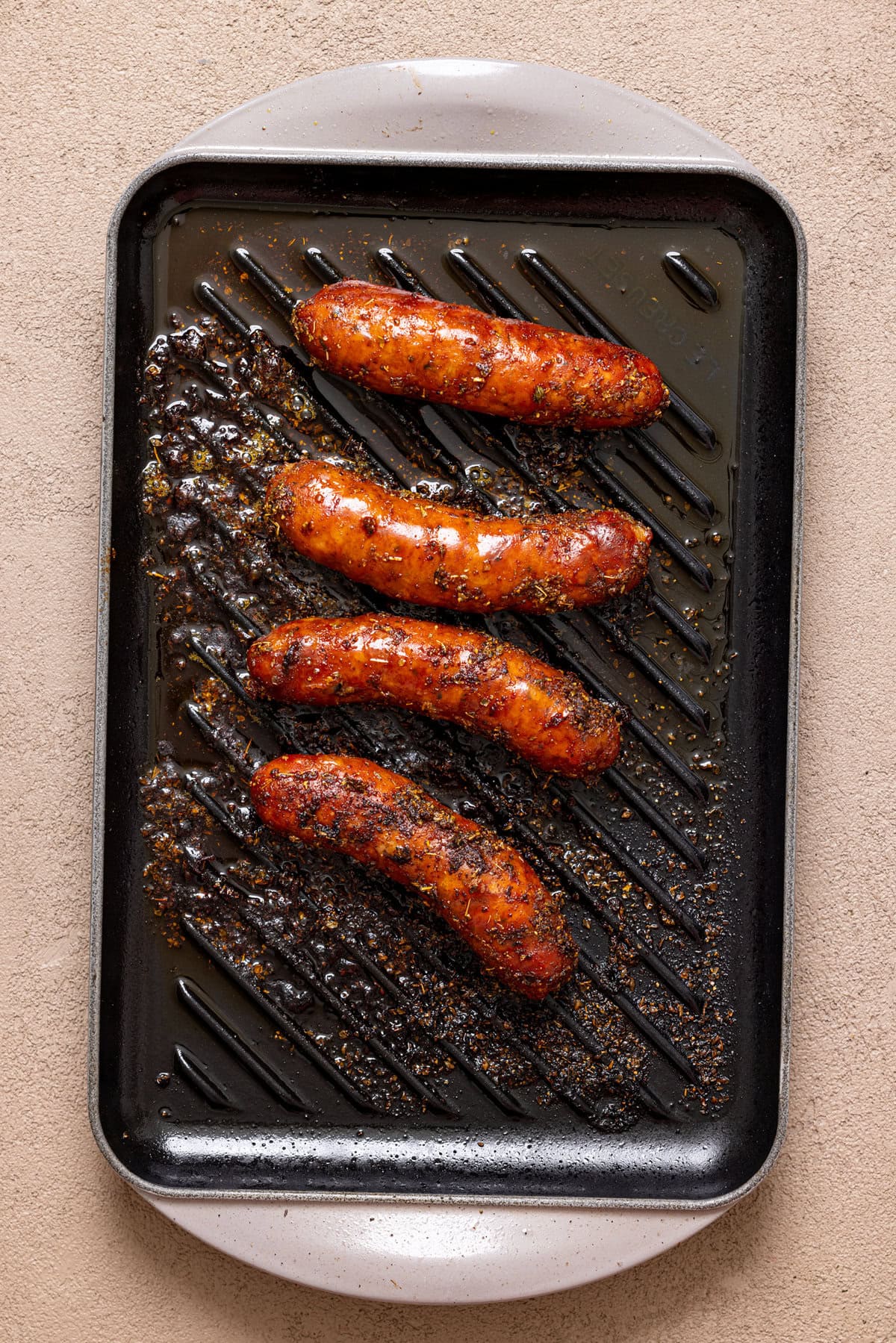 Grilled sausages on a grill pan.