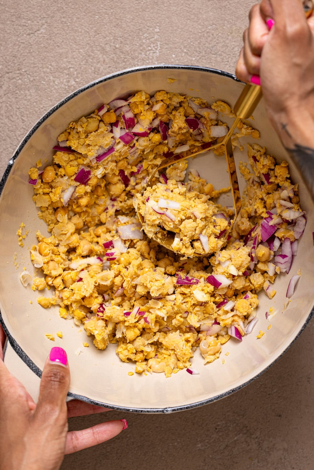 Filling ingredients being mashed in a bowl.