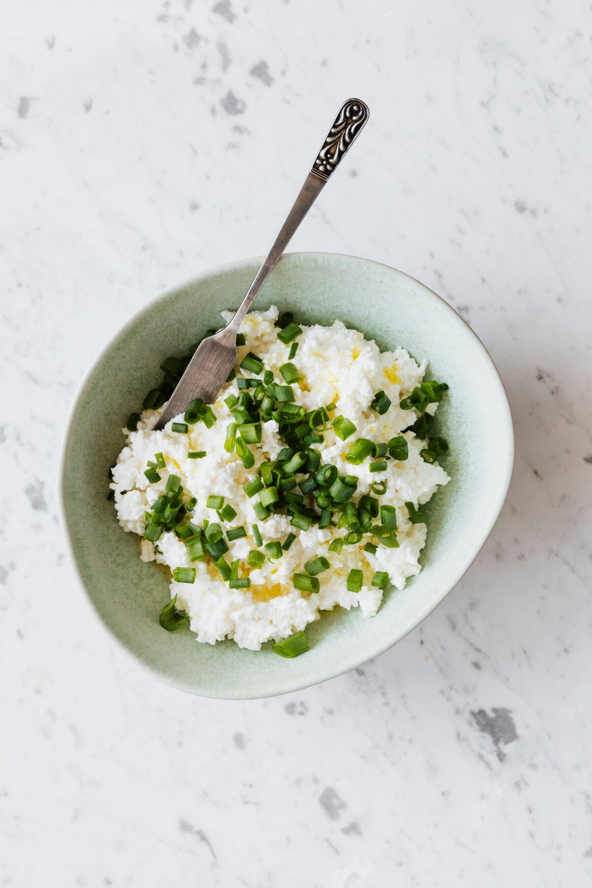 Ingredients in a white bowl with a silver knife.