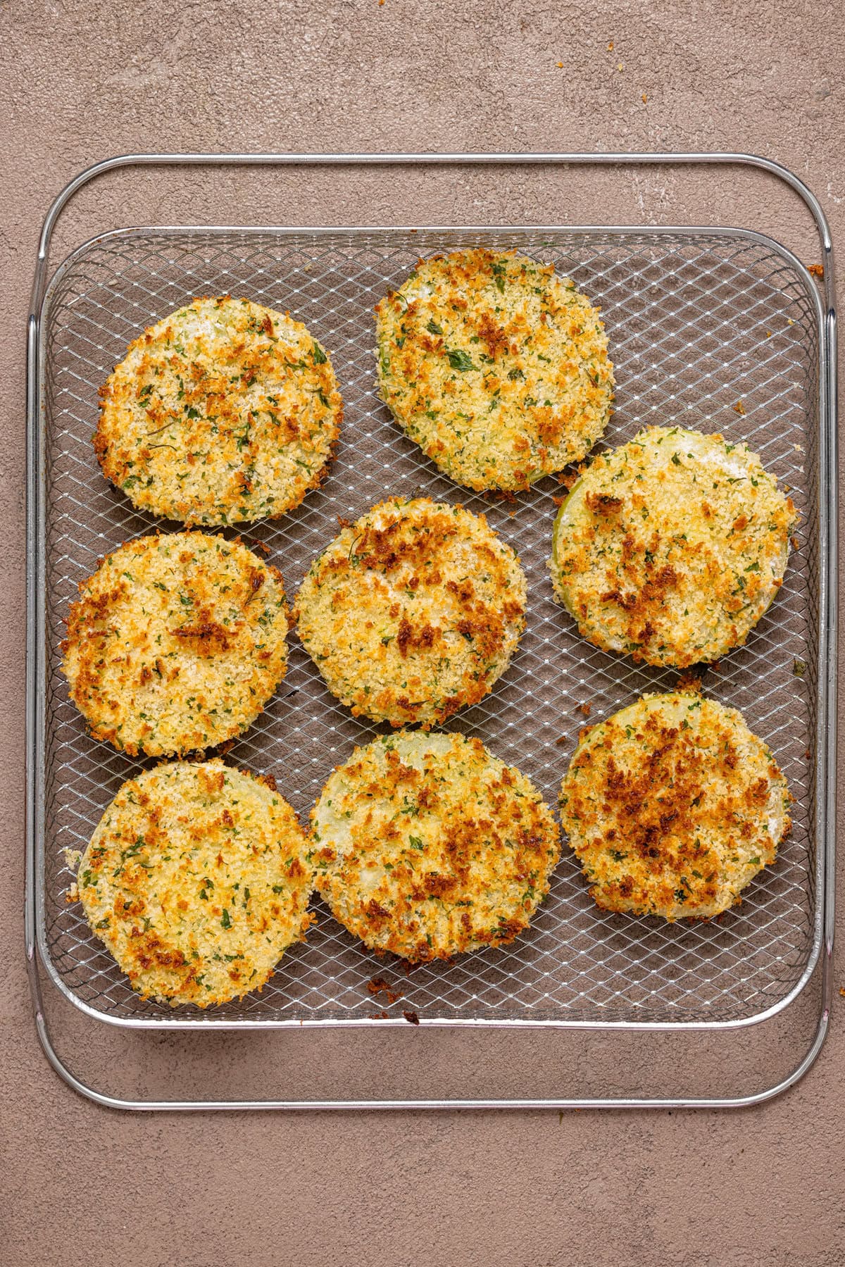 Air Fryer fried green tomatoes on a wire rack.