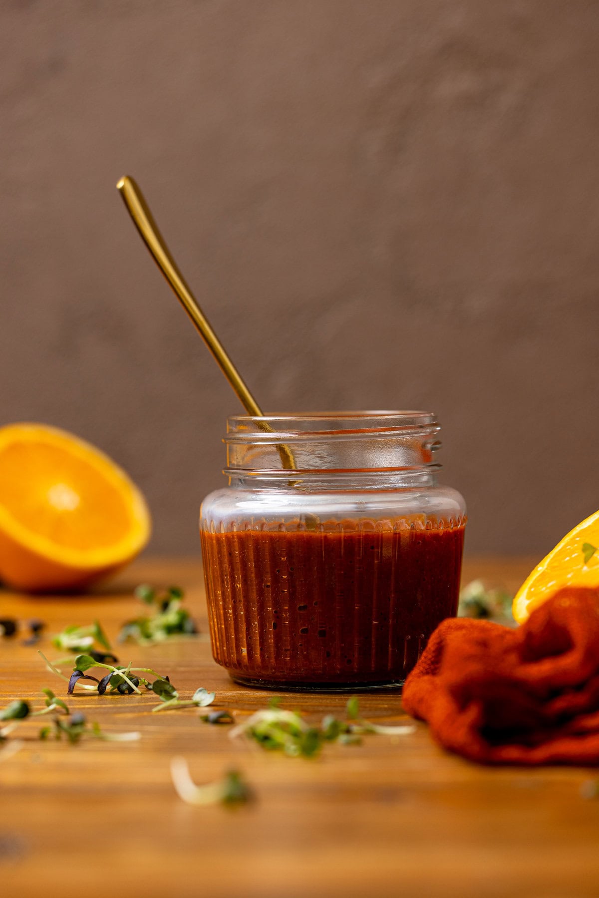 Al Pastor Marinade in a mason jar with a spoon and oranges.