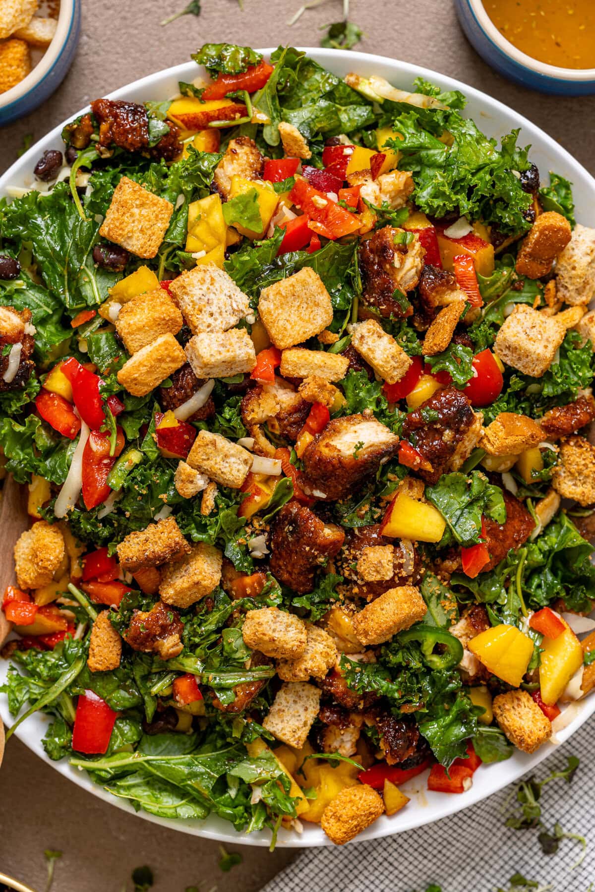 Up close shot of BBQ Chicken Peach salad in a serving bowl.