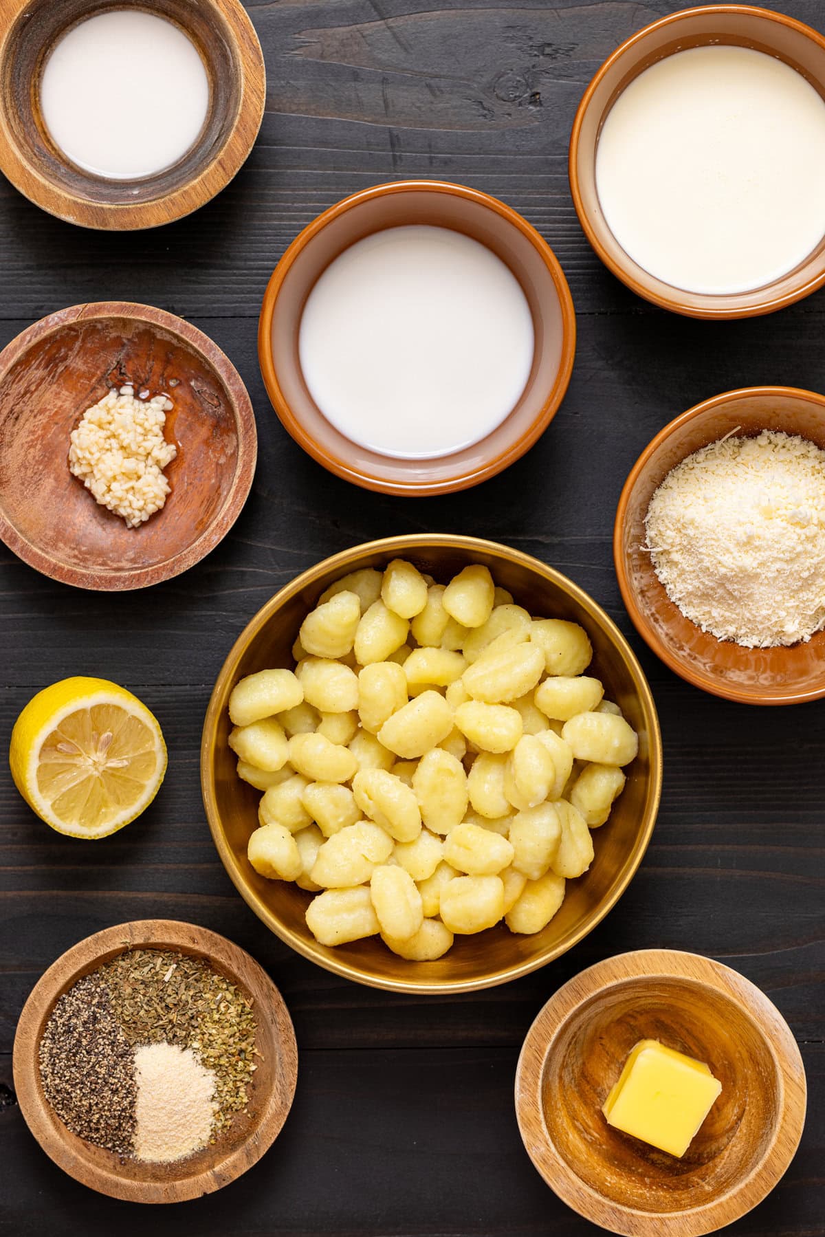 Ingredients on a black wood table.