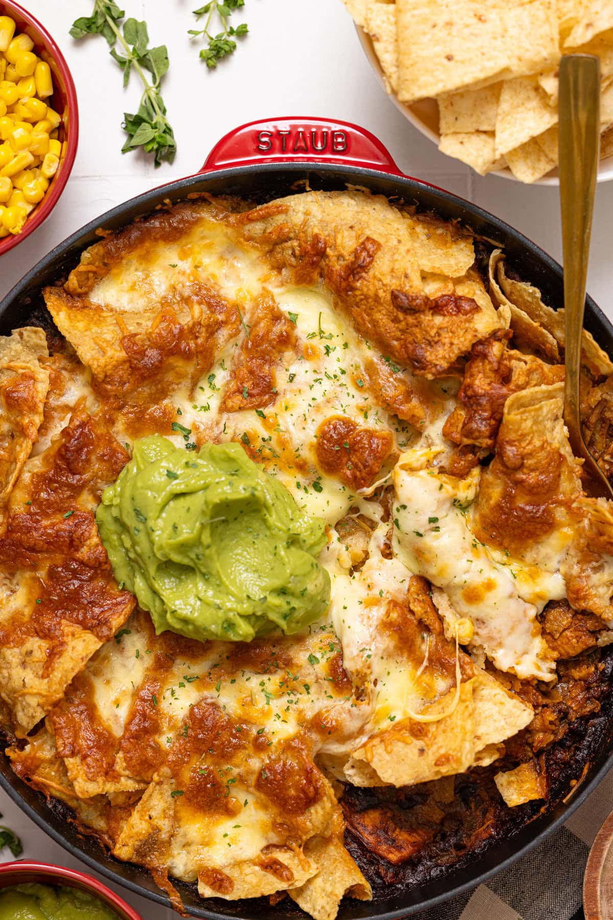 Baked enchilada in a skillet with guacamole. 