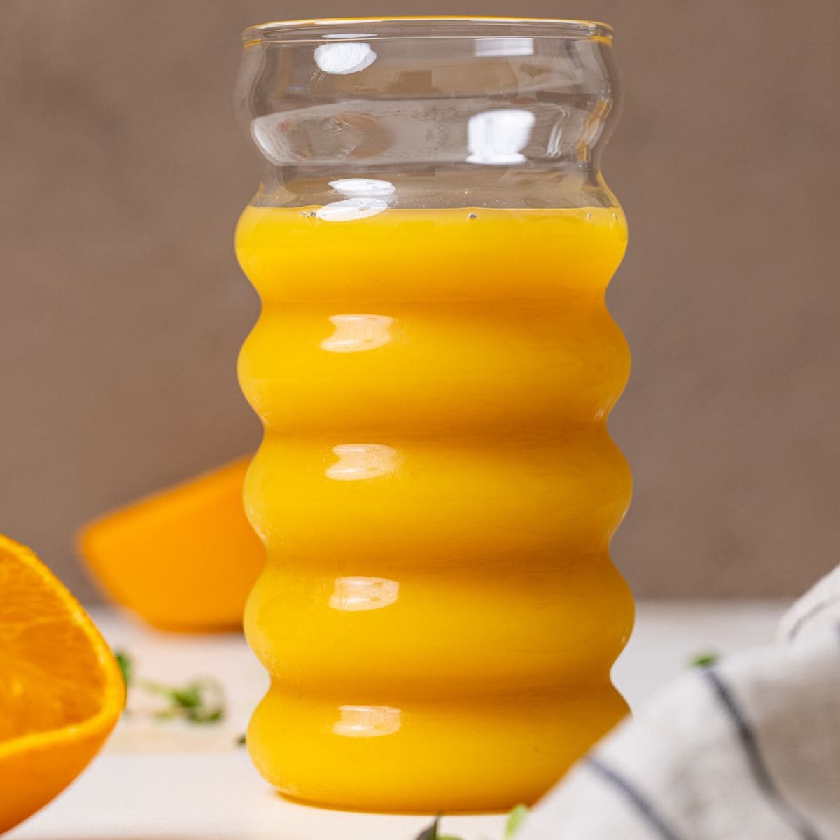 Tall glass of orange juice.