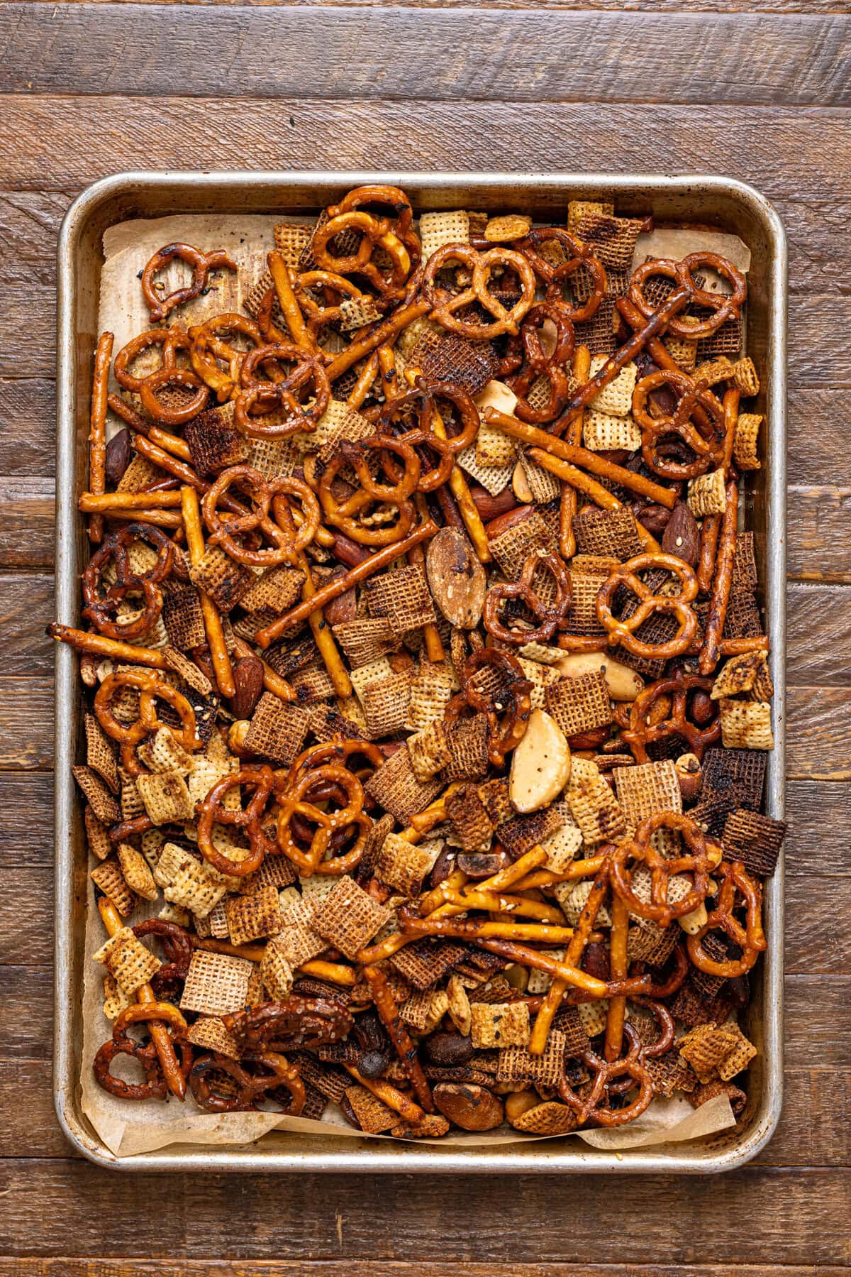 Chex mix baked on a baking sheet.