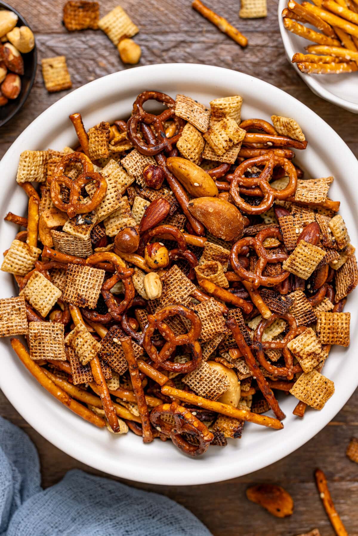 Up close shot of Chex mix in a white bowl.